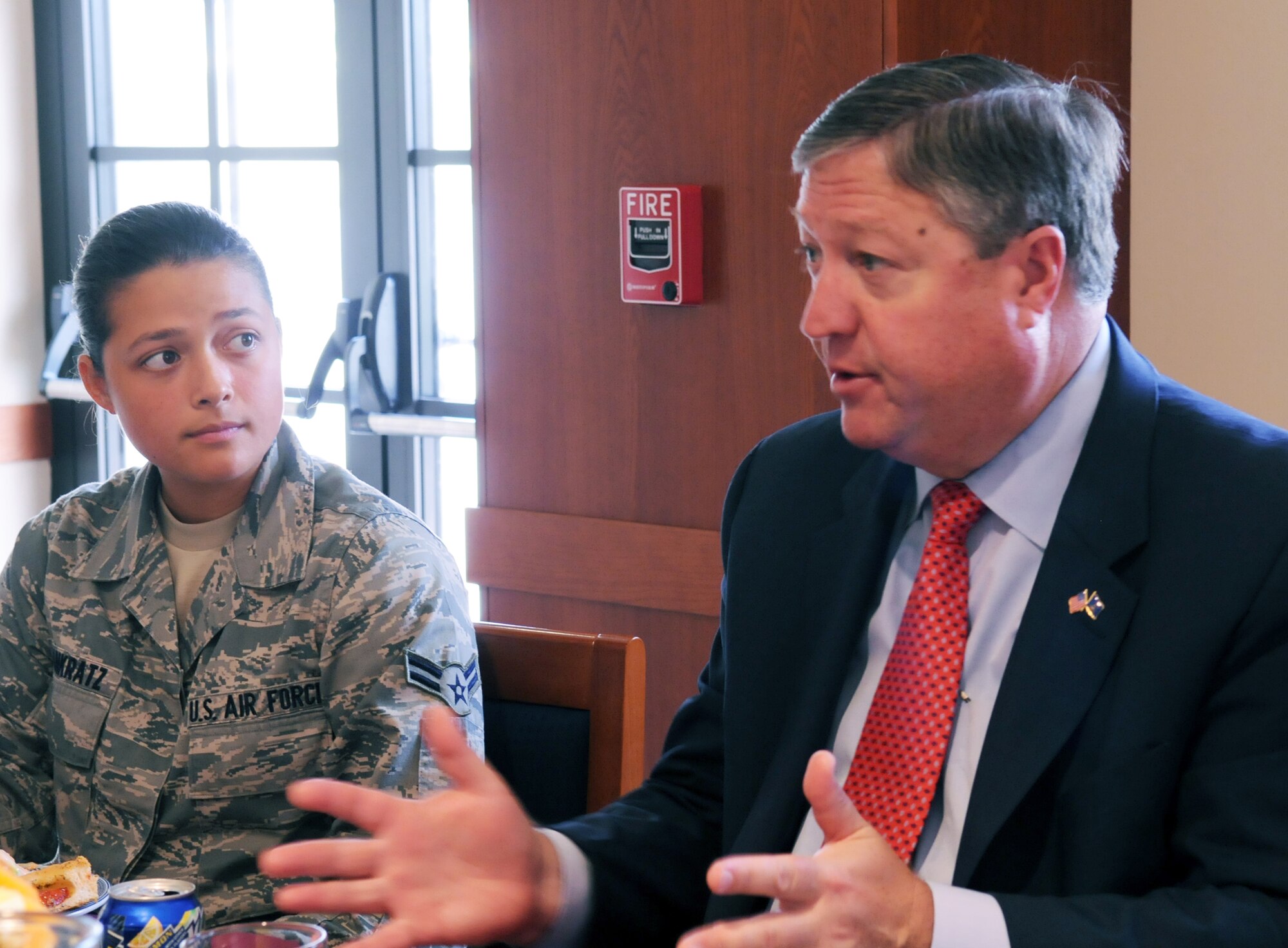Airman 1st Class Erika Raissa Pankratz, 603rd Air Control Squadron surveillance technician, listens as Secretary of the Air Force Michael Donley discusses health care and budgetary issues during a lunch with Airmen at the La Dolce Vita dining facility on Aviano Air Base, Italy, June 16, 2011. (U.S. Air Force photo/Airman Briana N. Jones)