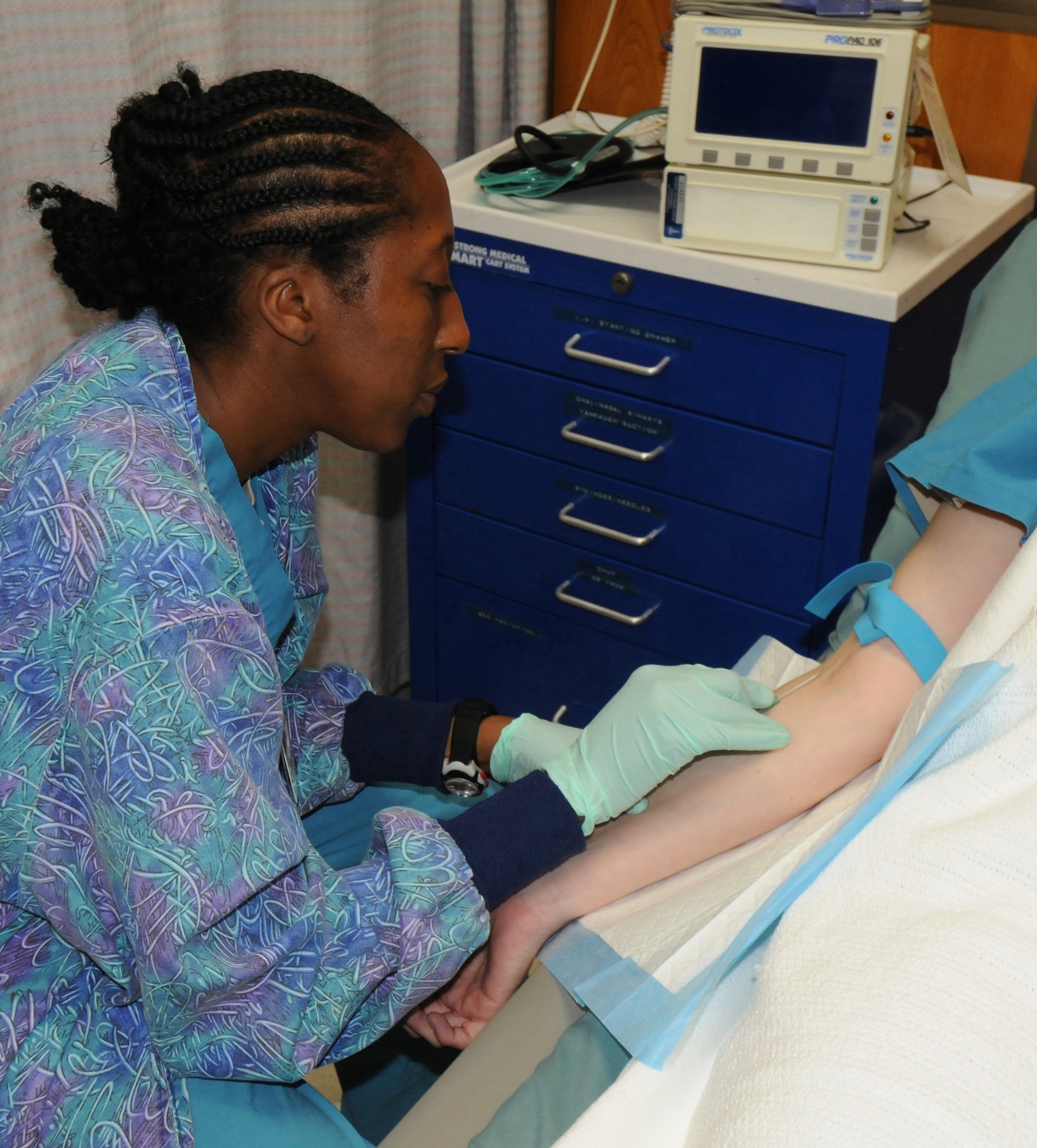 YOKOTA AIR BASE, Japan -- Staff Sgt. Eboni Scott, 374th Surgical Operations Squadron Same Day Surgery Unit medical technician, simulates administering an IV at Yokota Air Base, Japan, June 17, 2011. The unit handles pre- and post-surgery patient care to include checking vital signs, administering IVs and patient discharges. (U.S. Air Force photo/Airman John D. Partlow)
