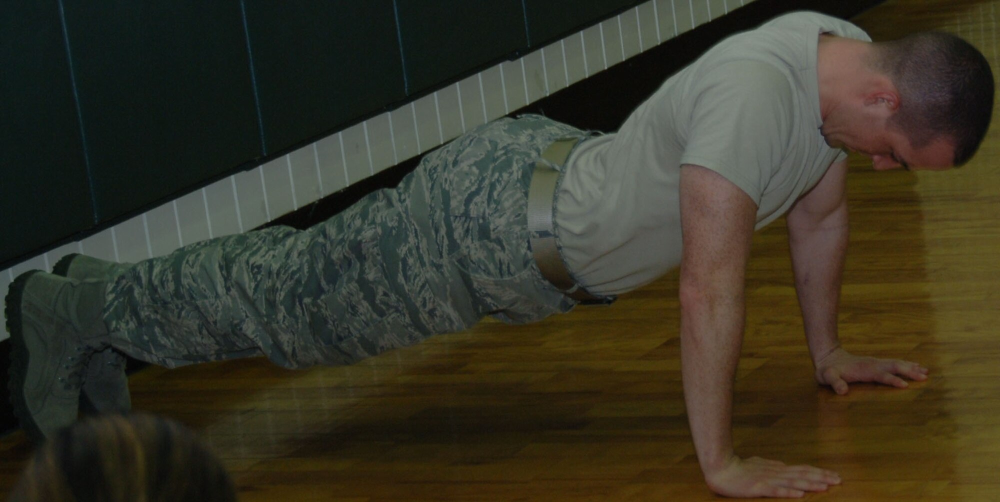 YOKOTA AIR BASE, Japan -- Senior Airman Jerry Copeland, 374th Maintenance Operation Squadron plans, scheduling and documentation, does push-ups during a competition at the Samurai Fitness Center at Yokota Air Base, Japan, June 16, 2011. During the competition, contestants had ten minutes to complete as many push-ups as they could. Sponsors donated money based on the number of push-ups accomplished by each contestant, raising money for the Yokota Chiefs' Group and the Enlisted Village. (U.S. Air Force photo/Airman 1st Class Lynsie Nichols)