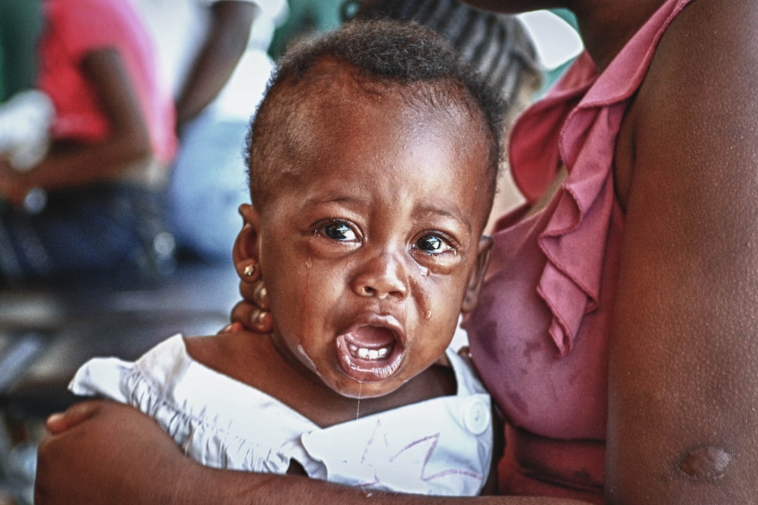 A Haitian baby diagnosed with bronchitis cries while receiving treatment from a U.S. Army nurse during a medical exercise as part of Task Force Bon Voizen in the city of Desdunes, Haiti, June 18, 2011. Task Force Bon Voizen is a U.S. Southern Command-sponsored joint foreign humanitarian exercise under the command of the Louisiana National Guard. The two-month exercise wraps up next week and service members already has treated more than 24,000 patients for medical and dental care.