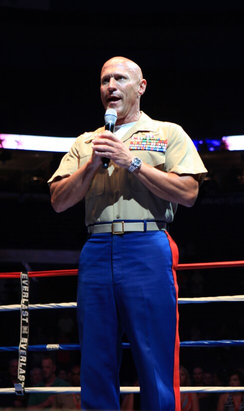 Lt. Col. Todd S. Tomko, commander of the Special Purpose Marine Air Ground Task Force Marine Week, sings the national anthem before the beginning of the First to Fight tournament in St. Louis June 20, 2011. First to Fight gave Marines a chance to box local police officers and firefighters while at the same time raising money for charity.