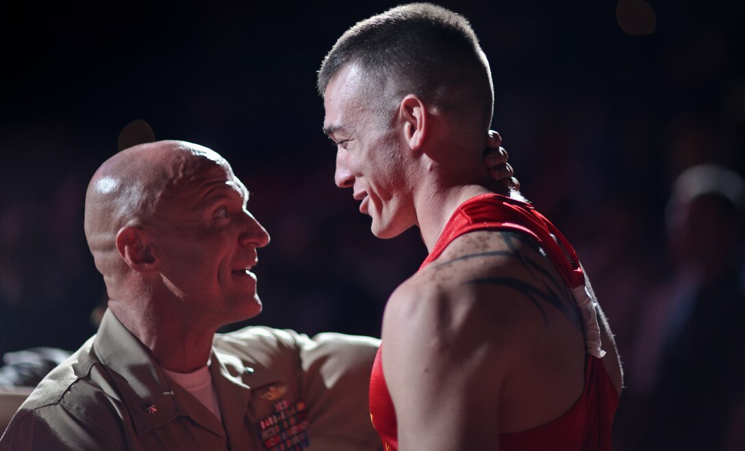 Lt. Col. Shane Tomko, Special Purpose Marine Ground Air-Ground Task Force commander with 3rd Battalion, 24th Marine Regiment gives words of encouragement to one of his Marines, Lance Cpl. Chris Williams, 22, a radio operator with the reserve battalion, before his fight at the "First to Fight" amateur boxing tournament. At this tournament, Marines and St. Louis police and firefighters go toe-to-toe at the Scottstrade Center in St. louis, June 20 with all proceeds benefitting Backstoppers, Semper Fi Foundation and Toys for Tots. Marine Week provides an opportunity to increase public awareness of the Marine Corps' value to our nation's defense and to preserve and mature the Corps' relationship with the American people. Photo by Sgt. Jimmy D. Shea
