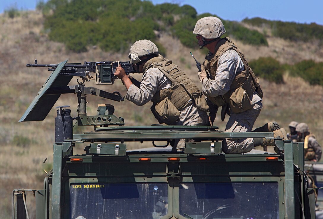 Lance Cpl. Phillip J. Martinez, left, and Cpl. Jesse L. Wolfenbarger participate in live-fire and motor-transport maneuver exercise here June 20. Martinez, 22, is from Santa Maria, Calif. Wolfenbarger, 27, is from White Pine, Tenn. The Marines serve with Combat Logistics Battalion 11, which provides logistics and services to the 11th Marine Expeditionary Unit.