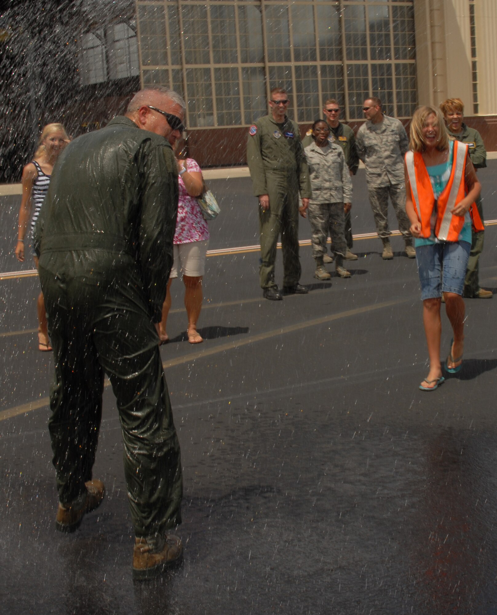 Lt. Col. James Golden, 15th Operations Group deputy commander, gets hosed down after completing his final flight at Joint Base Pearl Harbor-Hickam June 16. Family, friends and co-workers gathered on the flightline to greet Colonel Golden and bid their  farewells following his fini flight. Colonel Golden is making a permanent change of station to the Army War College in Pennsylvania.  (U.S. AIr Force photo/Ed Foster)