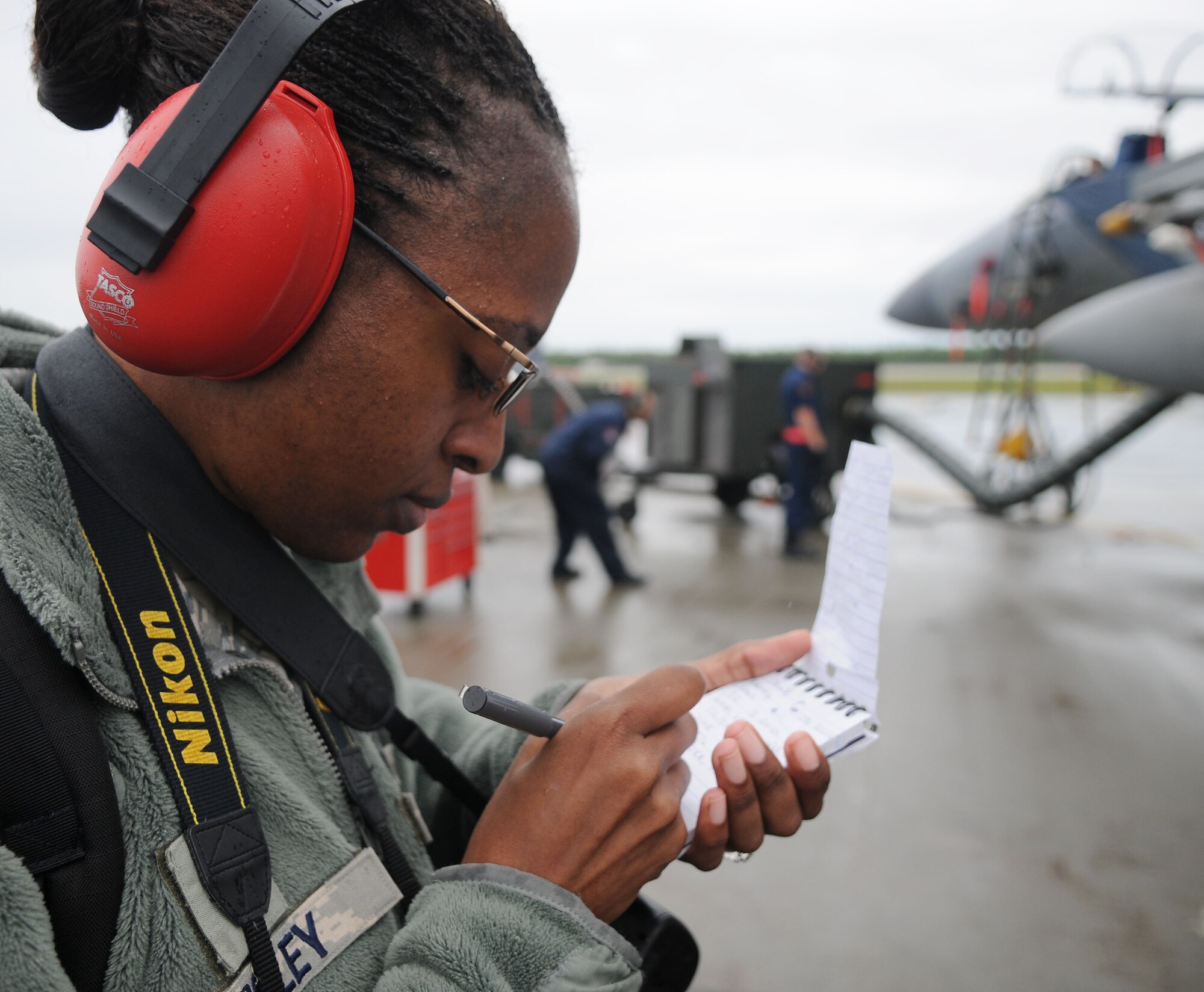 U.S. Air Force Staff Sgt. Lakisha Croley gathers information on the flightline for her photographs during the Northern Edge Premier Joint Training Exercise, June 20, 2011, at Eielson Air Force Base, Alaska. Sergeant Croley is a photographer assigned to the 18th Wing Public Affairs Office at Kadena Air Base, Japan. (U.S. Air Force photo/Senior Airman Rachelle Coleman)