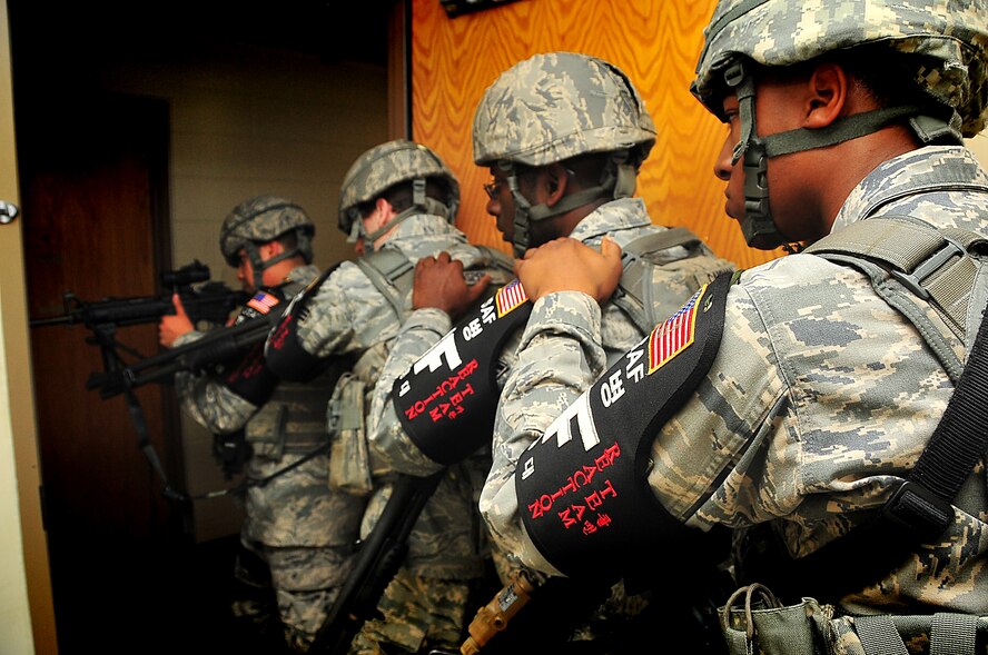 51st Security Forces quick reaction team clear an empty room, June 20 at Osan Air Base, Republic of Korea. Security Forces are responsible for ensuring the safety of bases, weapons, property and personnel from hostile forces. (U.S. Air Force Photo by Staff Sgt. Daylena Gonzalez)