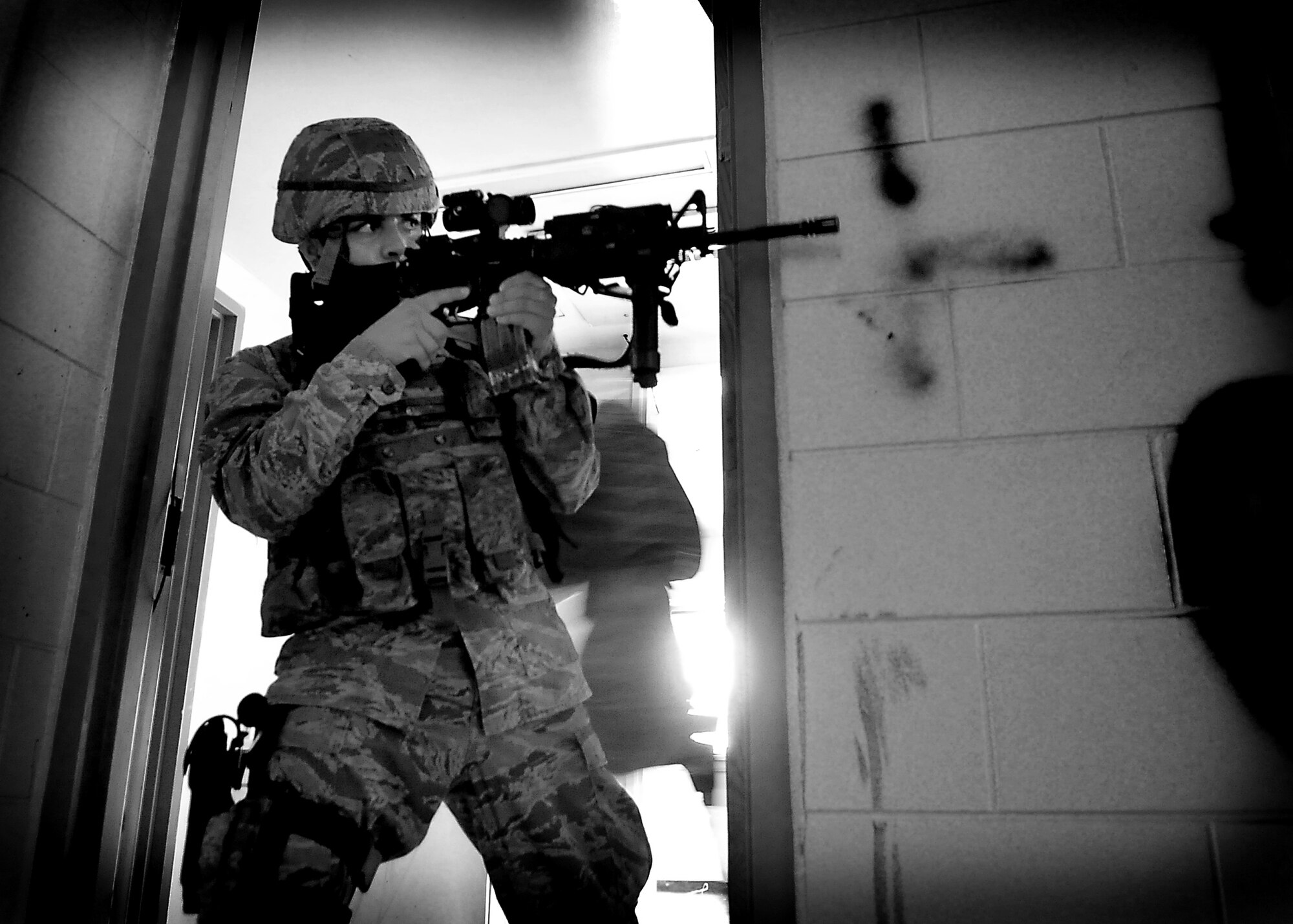 Airman 1st Class Jose Campos, 51st Security Forces Squadron, clears an empty room June 20 at Osan Air Base, Republic of Korea.  Security Forces is responsible for ensuring the safety of bases, weapons, property and personnel from hostile forces.  (U.S. Air Force Photo by Senior Airman Evelyn Chavez)