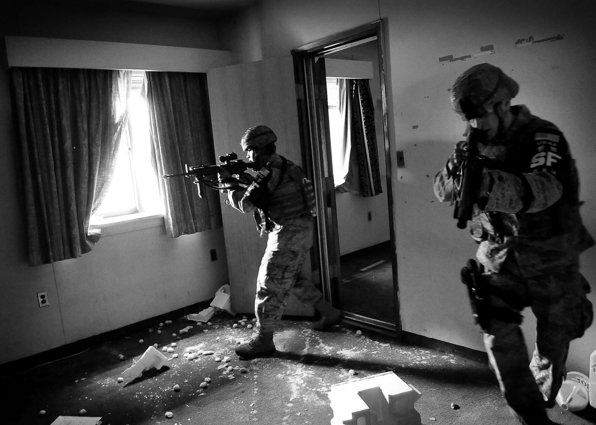 51st Security Forces members clear an empty room June 20 at Osan Air Base, Republic of Korea.  Security Forces is responsible for ensuring the safety of bases, weapons, property and personnel from hostile forces.  (U.S. Air Force Photo by Senior Airman Evelyn Chavez)