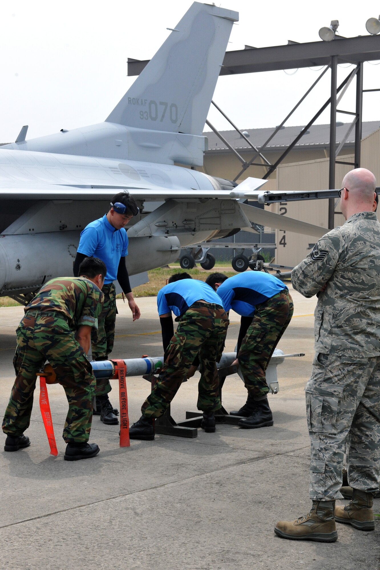 KUNSAN AIR BASE, Republic of Korea -- Republic of Korea Air Force 38th Aircraft Maintenance Squadron members perform a pre-check inspection before the semi-annual Weapons Loading Competition here June 18. Five teams, with three members each, represented Kunsan and Osan Air Bases, Davis-Monthan Air Force Base, Airz., and Royal Air Force Lakenheath, England, as well as the Republic of Korea Air Force 38th Fighter Group from Kunsan AB. (U.S. Air Force photo/Senior Airman Brittany Y. Bateman)