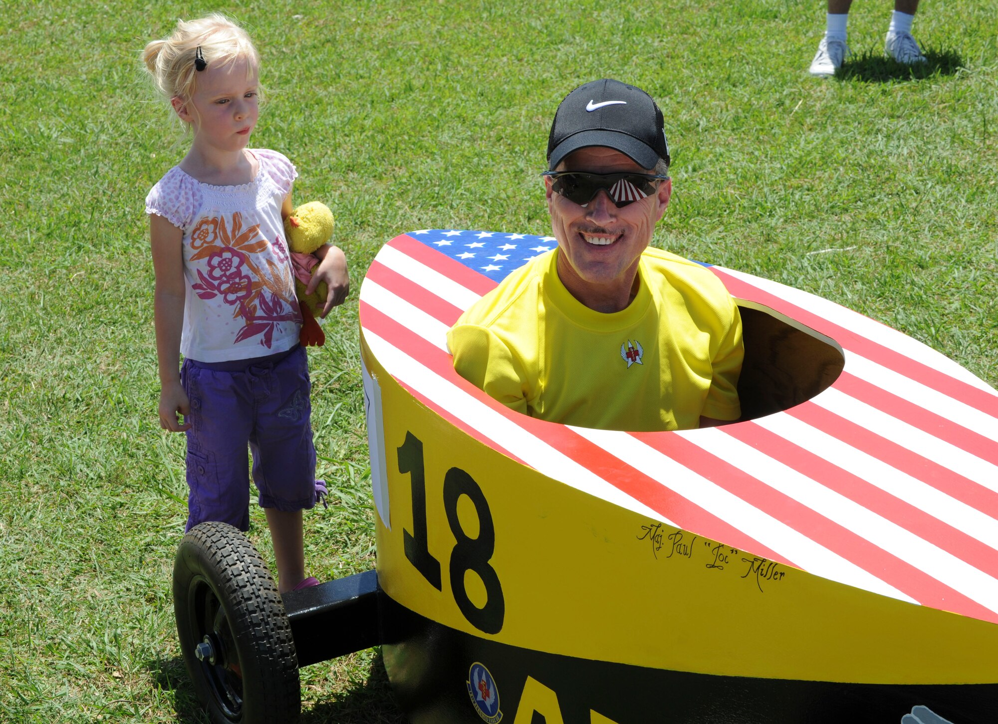 Maj. Paul Miller, 18th Aeromedical Evacuation Squadron, climbs into the driver’s seat of his derby car before the big race at the Kadena American Red Cross’s Derby Days, June 18. The 18th AES came in second place and won best car. (U.S. Air Force photo/Airman 1st Class Brooke P. Beers)