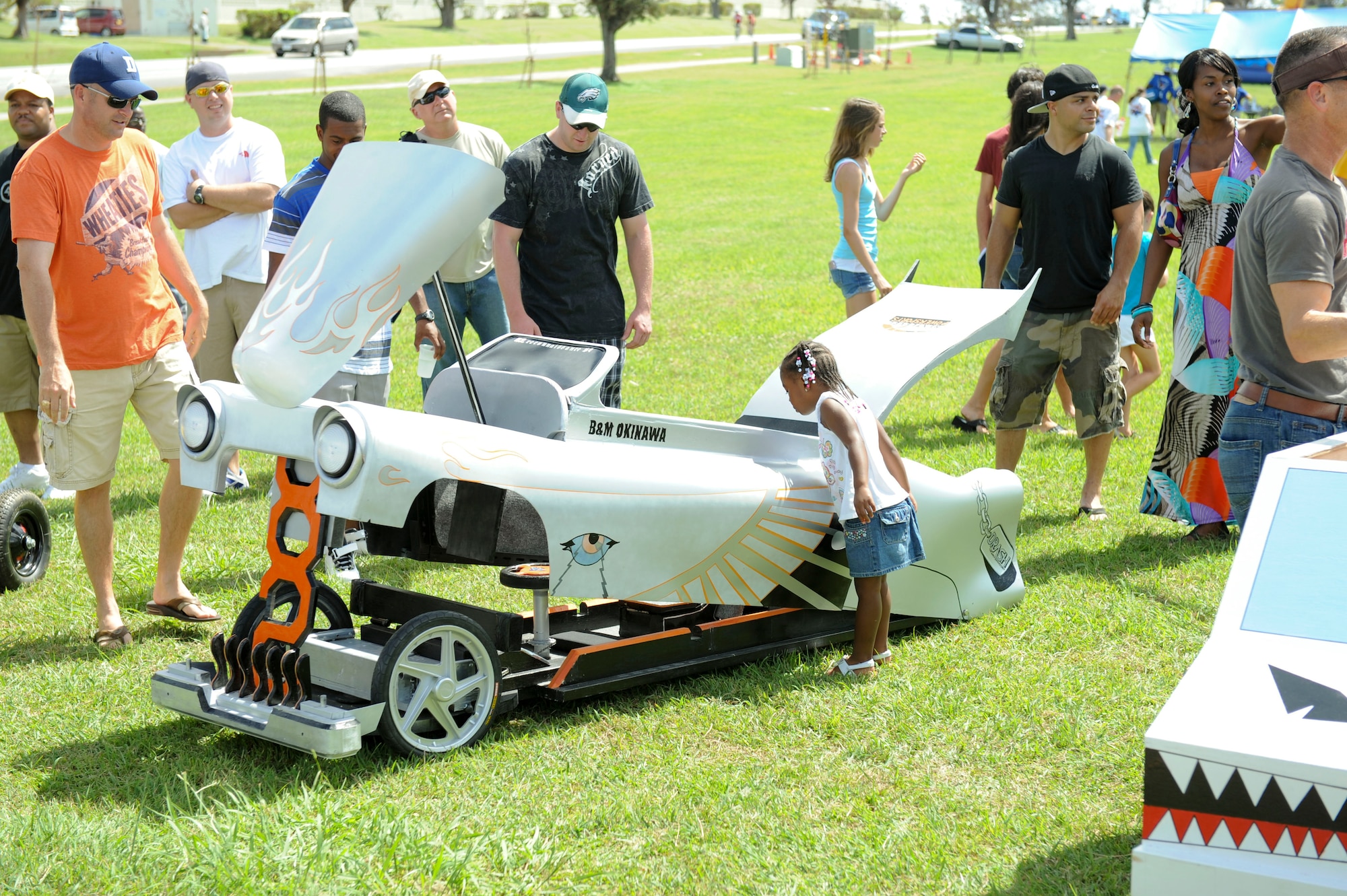 People admire the derby cars at Kadena?s Derby Days at Marek Park, June 18. The event was held to raise money for the Red Cross. (U.S. Air Force photo/Airman 1st Class Brooke P. Beers)