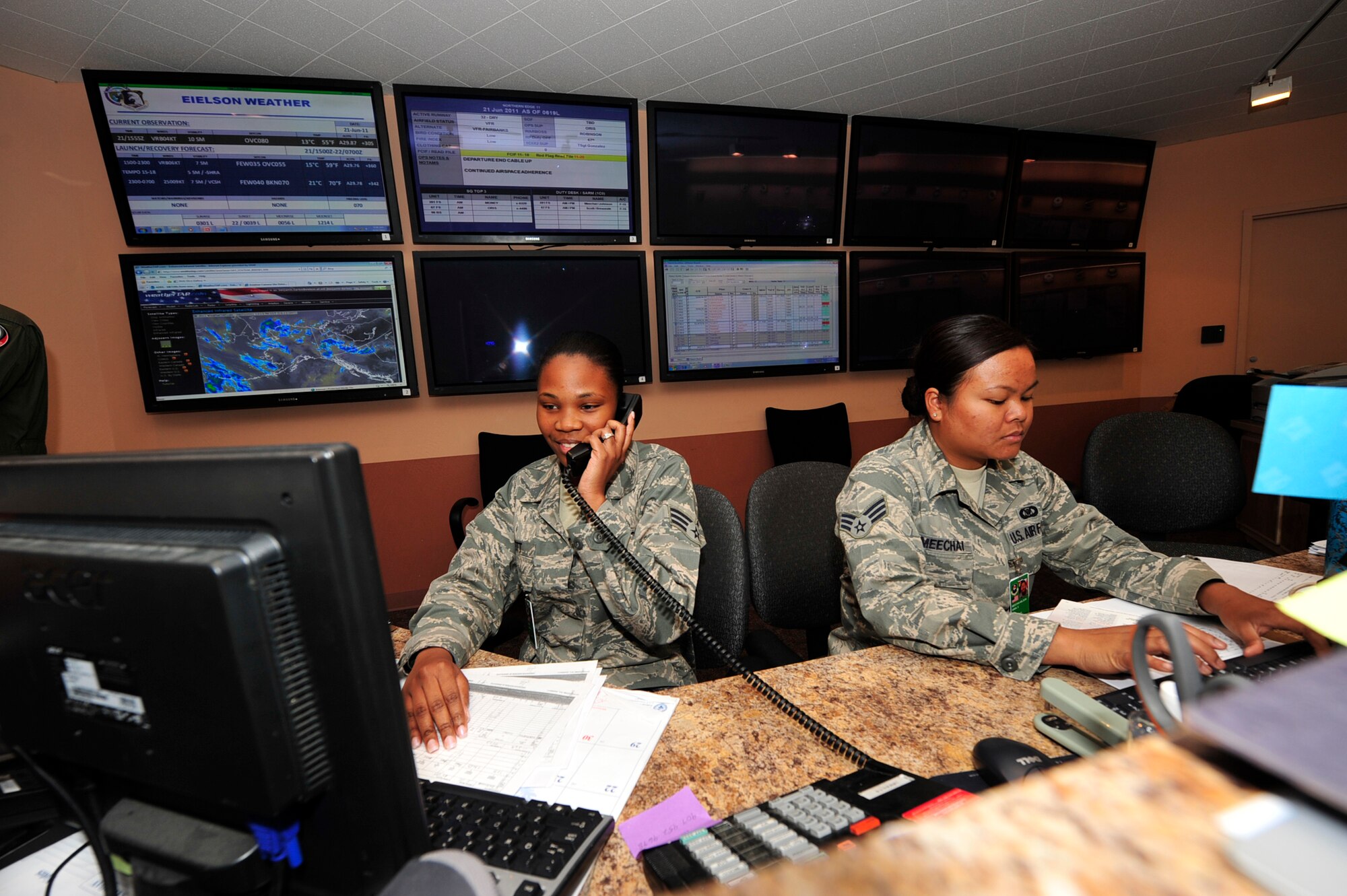 United States Air Force Senior Airmen Janay Scott and Anna Meechai ?Wilson, both squadron aviation resource management professionals, input training information into the Patriot Excalibur program and update the flying schedule during the Northern Edge Premier Joint Training Exercise at Eielson Air Force Base, Alaska, June 21. Virtually all Alaska-based Air Force and Army components participate in the exercise. Senior Airman Scott is assigned to the 67th Fighter Squadron, Kadena Air Force Base Japan and Senior Airman Meechai-Wilson is with the 391st Fighter Squadron, Mountains Home Air Force Base, Idaho. (U.S. Air Force photo/Staff Sgt. Lakisha A. Croley)