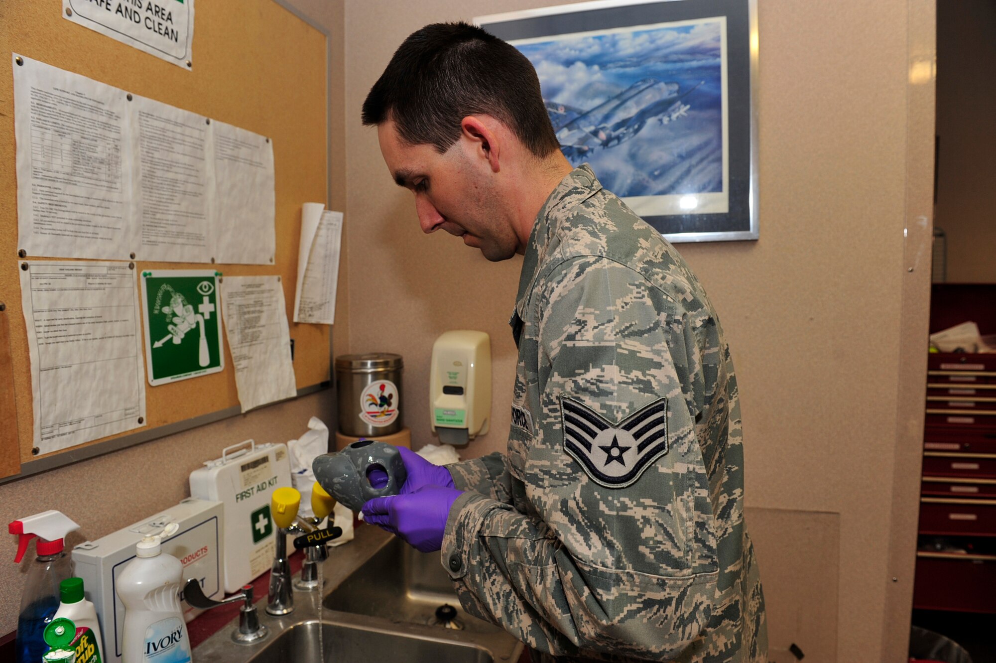 United States Air Force Staff Sgt. Nathan Davis, an aircrew flight equipment technician with the 18th Operations Support Squadron, Kadena Air Force Base, Japan, cleans the face mask of an HGU-55p helmet while conducting a periodic inspection during the Northern Edge Premier Joint Training Exercise, at Eielson Air Force Base, Alaska, June 21. More than 6,000 active duty, National Guard and Reserve Airmen receive training that prepares them for real-world missions during the exercise.   (U.S. Air Force photo/Staff Sgt. Lakisha A. Croley)