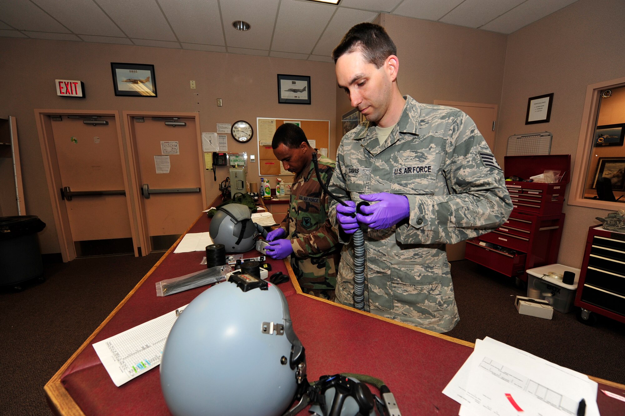 (From left to right) United States Air Force Tech. Sgt. Filmon Yosief and Staff Sgt. Nathan Davis, both, aircrew flight equipment technicians with the 18th Operations Support Squadron, Kadena Air Force Base, Japan, conduct a thirty-day inspection on HGU-55P helmets during the Northern Edge Premier Joint Training Exercise, at Eielson Air Force Base, Alaska, June 21. Northern Edge is Alaska?s largest military training exercise.  (U.S. Air Force photo/Staff Sgt. Lakisha A. Croley