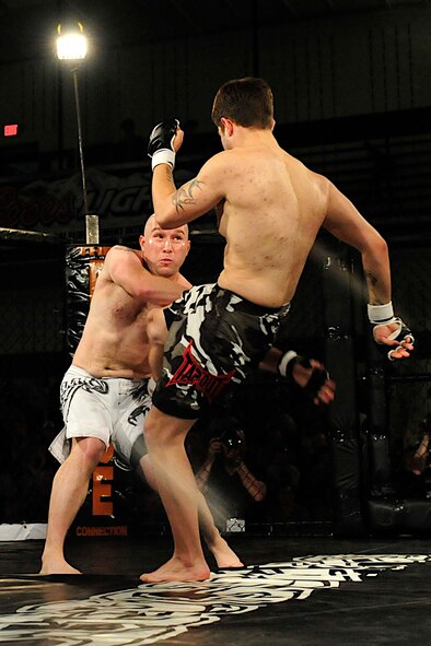 Staff Sgt. Daniel Turner, Air Force Financial Services Center auditor, blocks his opponents kick during a mixed martial arts fight June 17, 2011 at the Bellamy Fitness Center on Ellsworth Air Force Base, S.D. It was Sergeant Turner’s first fight in his life, and he won in 35 seconds. (U.S. Air Force photo/Master Sgt. Michael Morford/Released)