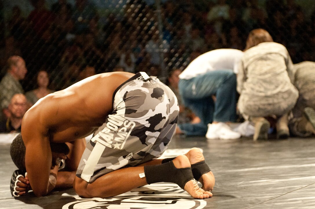 Senior Airman Jerel Guyton, 28th Medical Support Squadron health service management technician, regains his composure after knocking out his opponent during a mixed martial arts fight June 17, 2011 at the Bellamy Fitness Center on Ellsworth Air Force Base, S.D. The fight was hosted by the 28th Force Support Squadron and Ring Wars, an MMA organization from Rapid City, S.D. (U.S. Air Force photo/Tech. Sgt. Nathan Gallahan/Released)