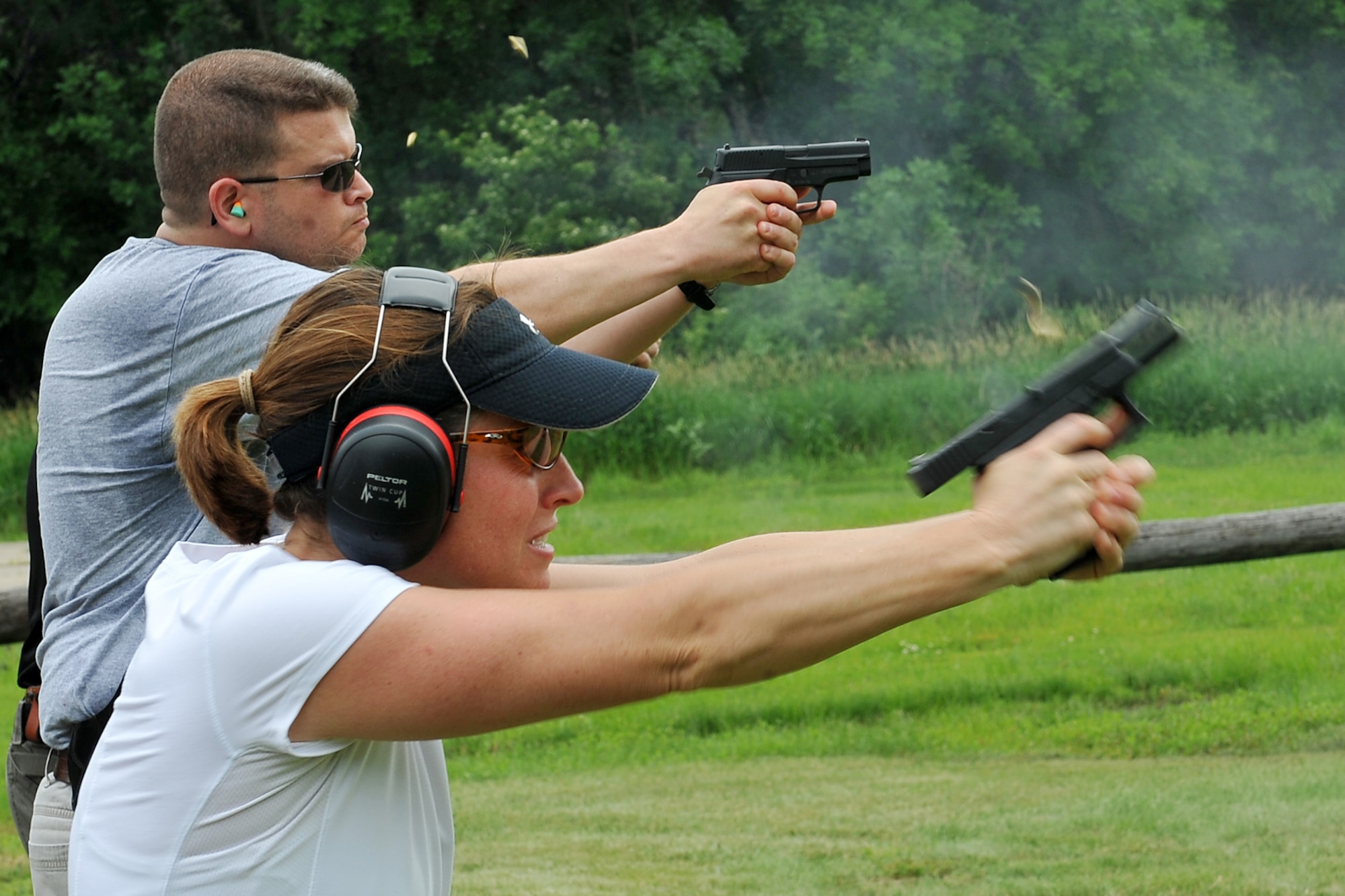 An FBI Agent shoots her weapon during the Air Force Office of Special Investigations pistol competition held at the Bellevue Rod and Gun Club in Bellevue, Neb. June 17. The Agent participated in a .6 mile run, shot her weapon from the kneeling position, and also shot at various targets all while being timed. 

U.S. Air Force Photo by Charles Haymond