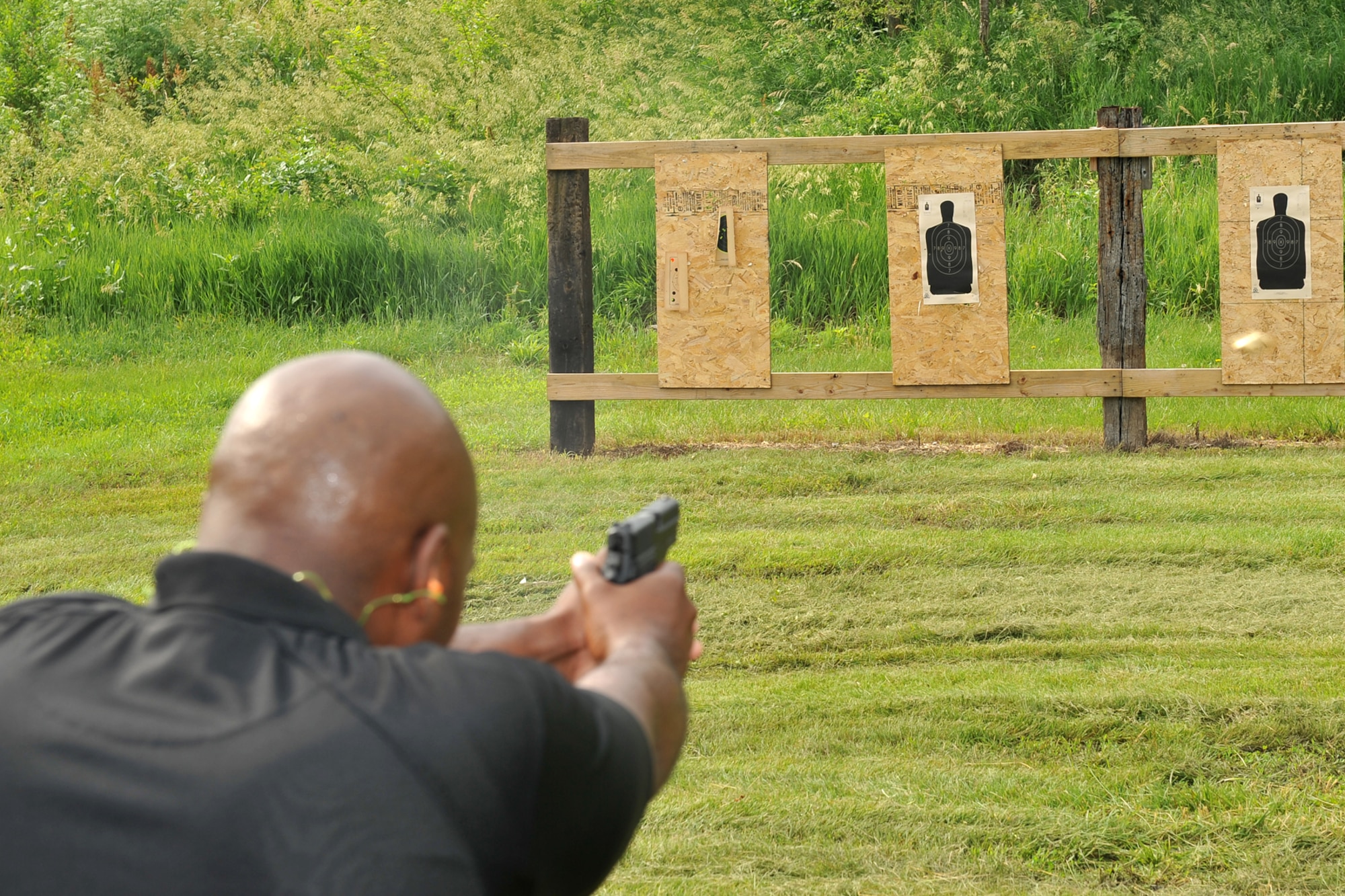 A special agent from the Air Force Office of Special Investigations shoots at a target during the AFOSI pistol competition held at the Bellevue Rod and Gun Club in Bellevue, Neb. June 17.  Various law enforcement agencies participated in this training exercise to sharpen their skills while strengthening the comradery between them. 

U.S. Air Force Photo by Charles Haymond/Release