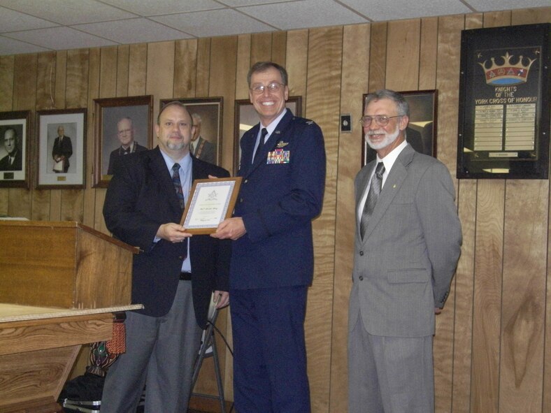 WRIGHT-PATTERSON AIR FORCE BASE, Ohio – New Carlisle Lodge #100 of Free and  Accepted Masons representatives Jeffery Pickett (on the left) and Ranold Seymour present Col. Stephen Goeman, 445th AW commander, with the Community Builders award May 19 in recognition of the wing’s outstanding service to the community. (Courtesy photo)