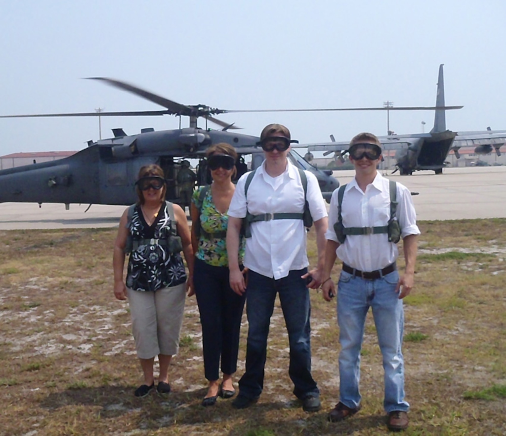PATRICK AIR FORCE BASE, Fla.- Deborah Wright , owner of The Green Room Cafe, Nancy Snyder, Senior Sales Manager at Hilton Melbourne Beach Oceanfront, Jeffrey "Scott" Dennis, Field Engineer for Hensel Phelps Construction and John Fisher, Project Manager for Hensel Pelps Construction, pose in front of a HH-60G Pave Hawk helicopter here, before flying north up the coast and around the shuttle launch pad. The primary mission of the HH-60G Pave Hawk helicopter is to conduct day or night personnel recovery operations into hostile environments to recover isolated personnel during war. (U.S. Air Force photo/Senior Airman Amanda Forshaw)