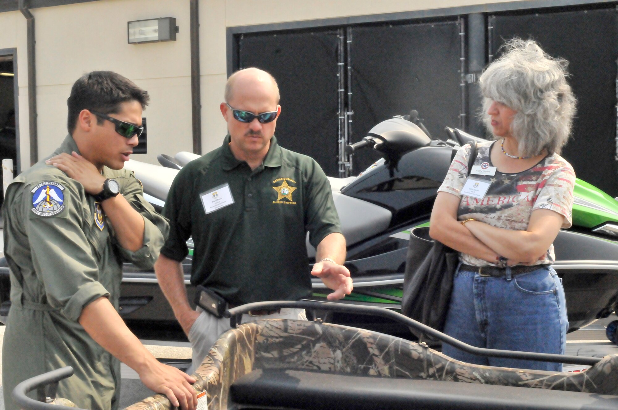PATRICK AIR FORCE BASE, Fla.- Senior Airman Kristopher Tomes, a pararescuemen here, explains to Alan Moros, Brevard County Sheriff Commander and Cathy Haynes, Central Florida Navy League, how the vehicles on display are used to assist the PJs n their mission. Pararescuemen are the only Department of Defense specialty specifically trained and equipped  to conduct conventional or unconventional rescue operations. All reservists here are combat search and rescue trained and are ready at a moment's notice to provide assistance as needed. (U.S. Air Force photo/Airman First Class Natasha Dowridge)