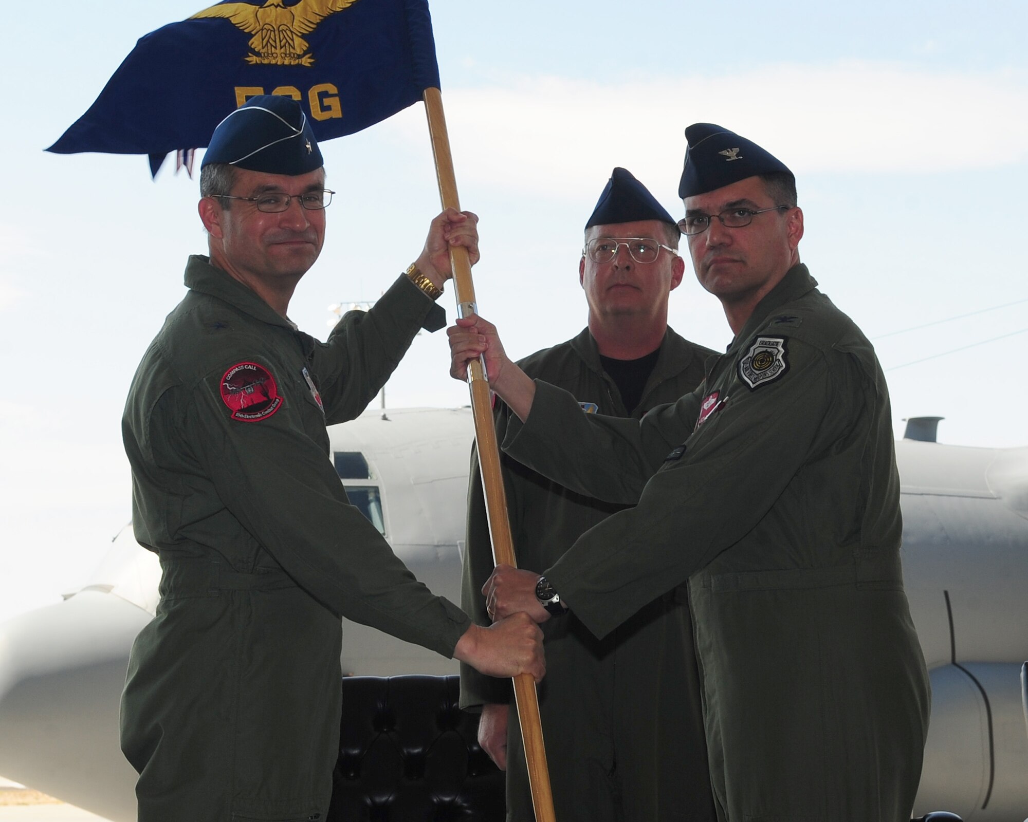 DAVIS-MONTHAN AIR FORCE BASE, Ariz. - Col. Dean Worley, (right) 55th Electronic Combat Group commander relinquishes command during a change- of- command ceremony at the 755th Aircraft Maintenance Squadron hangar, Davis-Monthan Air Force base, AZ, June 17. Brig. Gen. Donald Bacon, 55th Wing commander, presided over the ceremony welcoming Colonel Richard Fojtik as the new commander. (U.S. Air Force photo/Airman 1st Class Jerilyn Quintanilla)