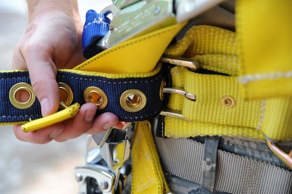 Senior Airman Matthew Baldyga unbuckles the safety harness after climbing the radio frequency tower for training at Naval Weapons Station Charleston, June 14. Airman Baldyga is a radio frequency transmissions journeyman with the 628 Communications Squadron. (U.S. Air Force photo/Staff Sergeant Katie Gieratz)