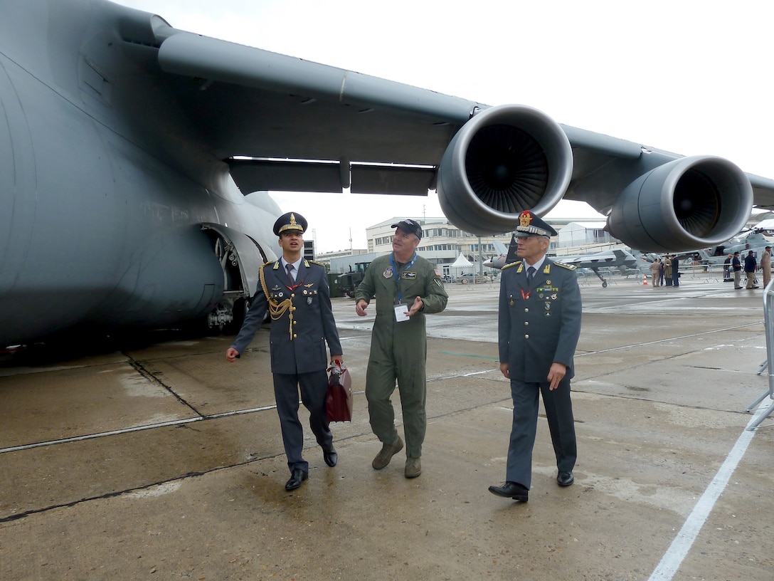 Lt. Col. Mark Alderson (center) discusses the capabilities of the C-5M Super Galaxy with members of the Italian army June 20, 2011, during the 49th International Paris Air Show at the Le Bourget Airport in Paris. Colonel Alderson is a pilot assigned to the 709th Airlift Squadron at Dover Air Force Base, Del. (U.S. Air Force photo/Tech. Sgt. Francesca Popp)