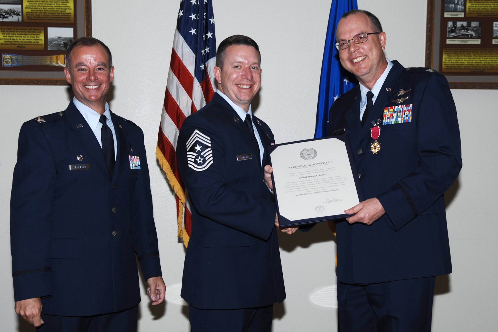 GOODFELLOW AIR FORCE BASE, Texas -- Col. James Forrest, 17th Medical Group Commander, and Chief Master Sgt. Brendan Criswell, 17th Training Wing Command Chief, present a letter of appreciation from the Chief Master Sgt. of the Air Force to Col. David Rearick, 17th TRW Vice Commander, during his retirement ceremony June 20. Colonel Rearick retired after 24 years of service. (U.S. Air Force photo/Staff Sgt. Laura R. McFarlane)