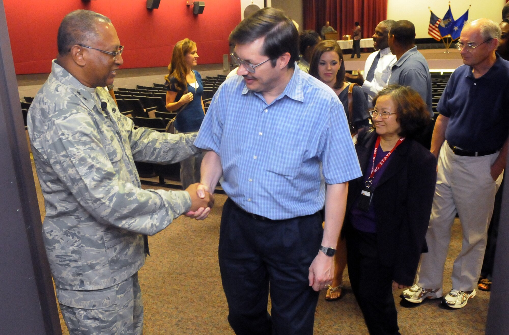 Maj. Gen. Gary T. McCoy shakes hands and speaks with workforce members after a town hall meeting during his visit to Robins. U. S. Air Force photo by Sue Sapp