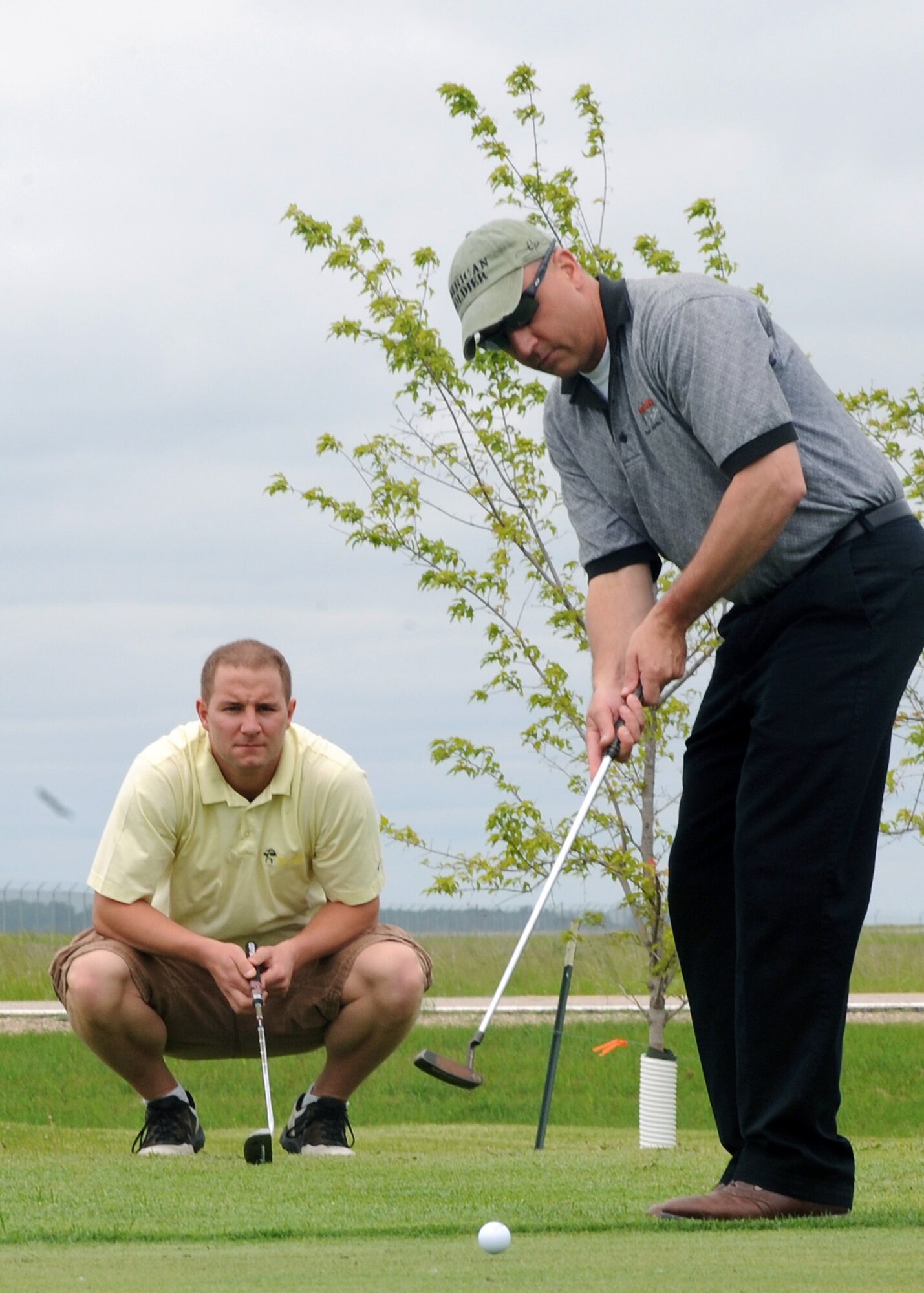 Lt. Col. Darin Driggers, 319th Operations Support Squadron commander, hits the ball during the Military Affairs Committee Golf Tournament June 20, 2011, on Grand Forks Air Force Base, N.D. The tournament is held annually to support and strengthen the relationship between the Base and the community. (U.S. Air Force photo by Senior Airman Amber Bennett)