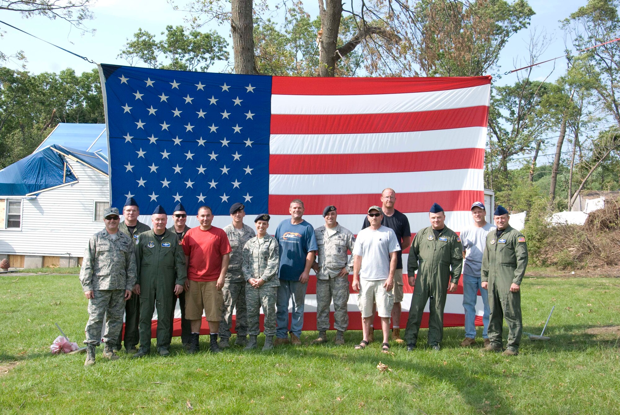 Members of the Security Forces and the 337th Airlift Squadron at Westover ARB donated an installation flag June 15 to Master Sgt. Daniel Sullivan, a resident of Springfield, Mass., who was hit hard by the June 1 tornadoes. For the past decade Master Sgt. Sullivan has displayed a large flag in his front yard. After the tornadoes, his flag was in a state of disrepair.