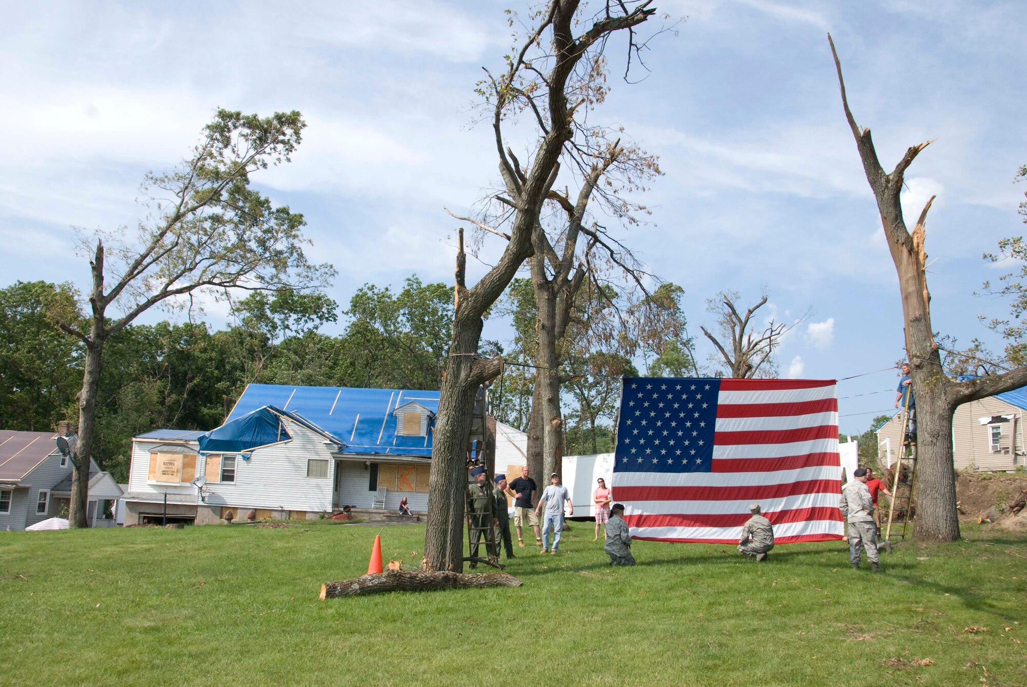 Members of the Security Forces and the 337th Airlift Squadron at Westover ARB donated an installation flag June 15 to Master Sgt. Daniel Sullivan, a resident of Springfield, Mass., who was hit hard by the June 1 tornadoes. For the past decade Master Sgt. Sullivan has displayed a large flag in his front yard. After the tornadoes, his flag was in a state of disrepair.