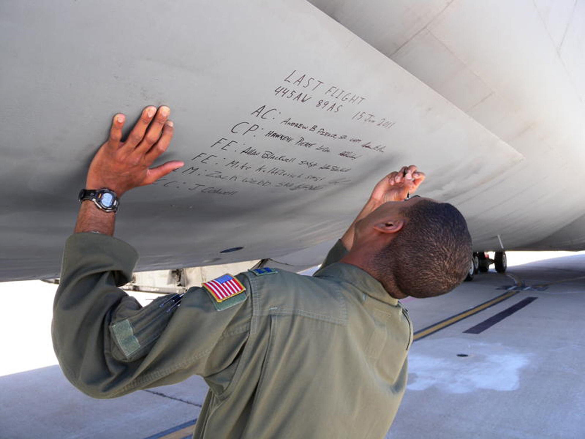 WRIGHT-PATTERSON AIR FORCE BASE, Ohio – Capt. Andrew Pierce, 89th Airlift Squadron pilot, signs his name on the nose landing gear door on a C-5 Galaxy June 15. The crew delivered tail number 447 to its final resting place at the 309th Aerospace Maintenance and Regeneration Group, also known as “The Boneyard,” Davis-Monthan Air Force Base, Ariz., for permanent storage and retirement.  The 309 AMARG will eventually prep and store C-5s from the 445th that will not go to other units. (U.S. Air Force photo/Senior Master Sgt. Michael Kalbfleisch)