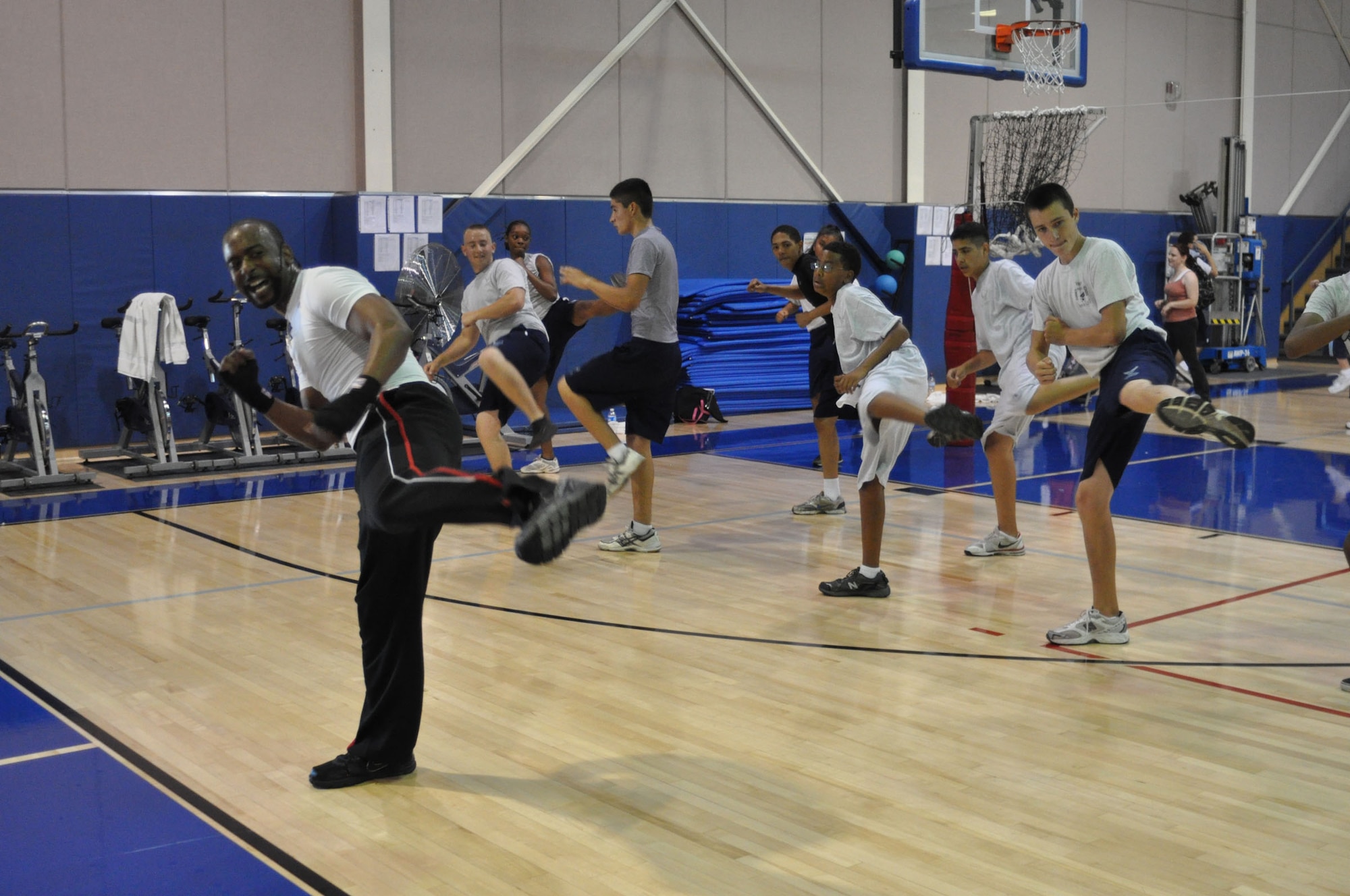 452nd Air Mobility Wing Fitness Center instructor George Grady leads a kickboxing class for Air Force JROTC cadets attending Summer Leadership School at March Air Reserve Base, Calif., June 15, 2011. Approximately 50 cadets from Rancho Verde High School in Moreno Valley, Calif., and Arlington High School in Riverside, Calif., participated in the two-week school this year. (U.S. Air Force photo/Megan Just)