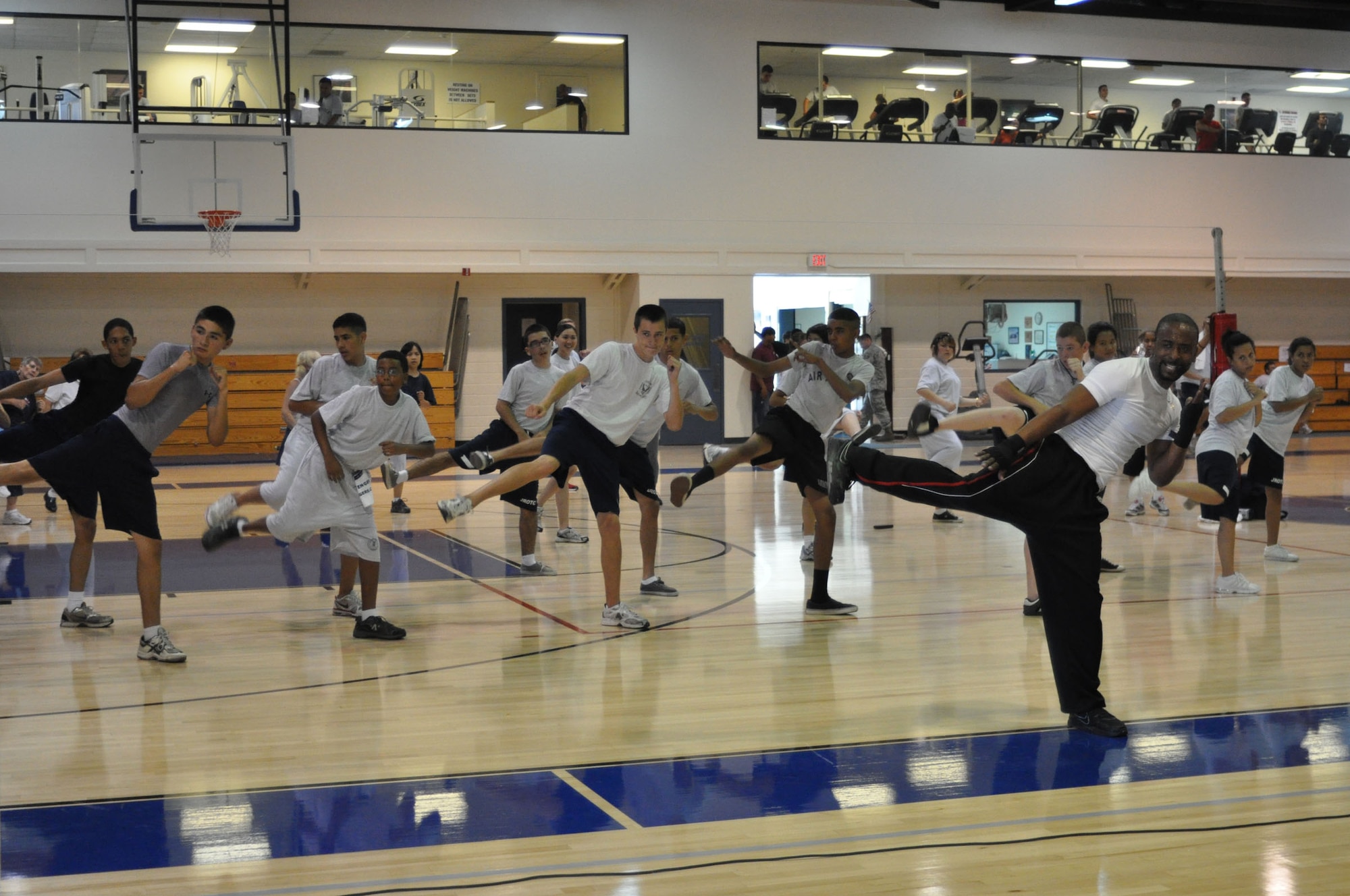452nd Air Mobility Wing Fitness Center instructor George Grady leads a kickboxing class for Air Force JROTC cadets attending Summer Leadership School at March Air Reserve Base, Calif., June 15, 2011. Approximately 50 cadets from Rancho Verde High School in Moreno Valley, Calif., and Arlington High School in Riverside, Calif., participated in the two-week school this year. (U.S. Air Force photo/Megan Just)