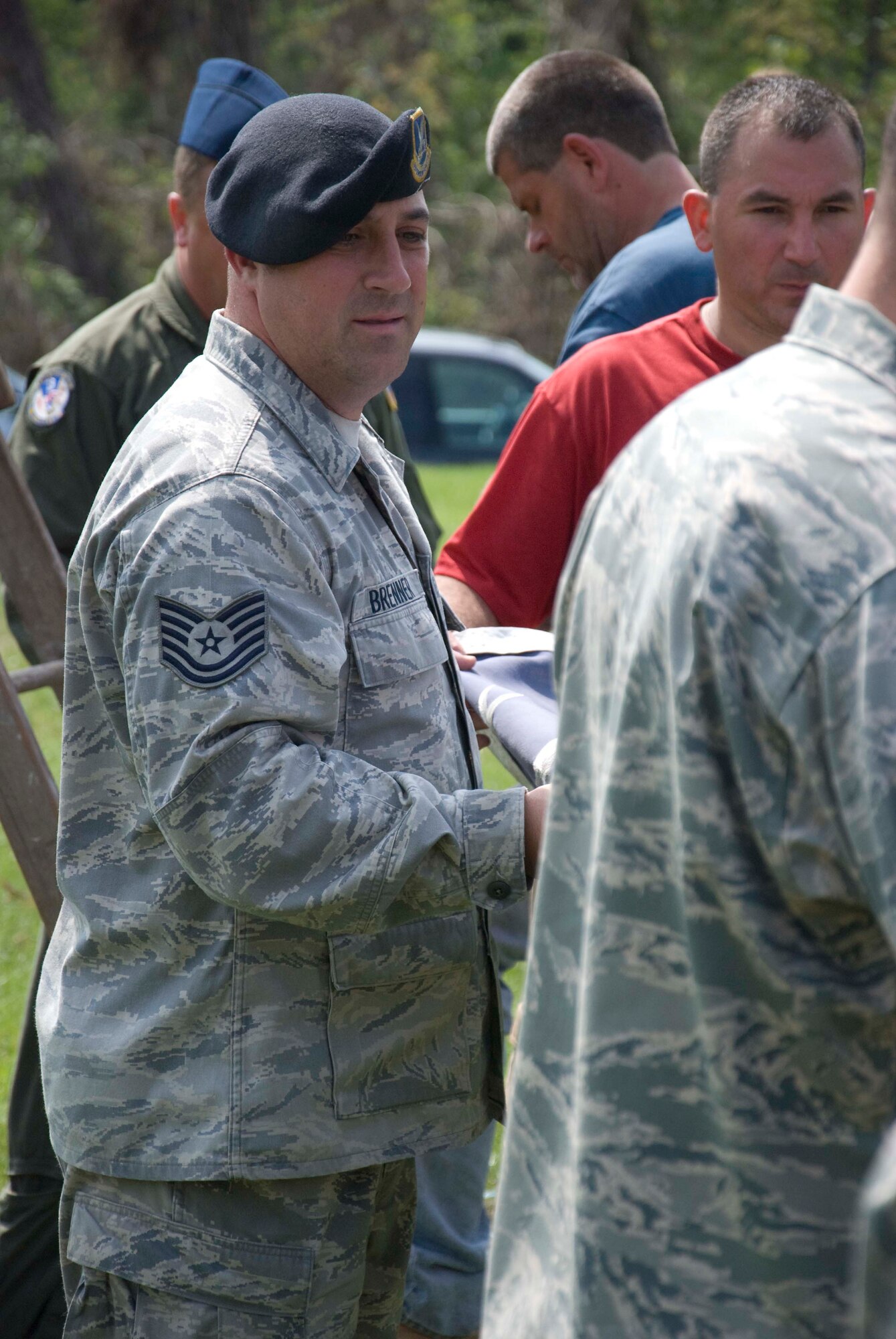 Members of the Security Forces and the 337th Airlift Squadron at Westover ARB donated an installation flag June 15 to Master Sgt. Daniel Sullivan, a resident of Springfield, Mass., who was hit hard by the June 1 tornadoes. For the past decade Master Sgt. Sullivan has displayed a large flag in his front yard. After the tornadoes, his flag was in a state of disrepair.