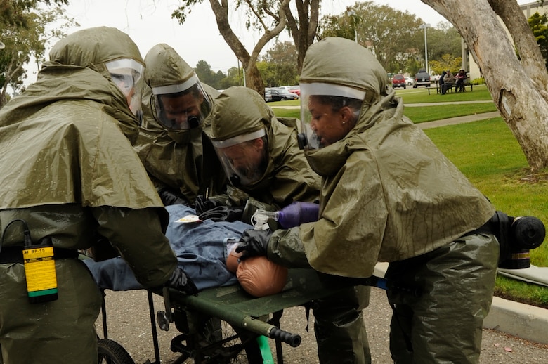 VANDENBERG AIR FORCE BASE, Calif. – Members of the 30th Medical Group provide medical care during an In Place Patient Decontamination training course at the clinic here Thursday, June 16, 2011. The IPPD training, conducted by DECON, LLC, taught Airmen how to care for patients in hazardous situations while constructing a decontamination facility. (U.S. Air Force photo/Senior Airman Lael Huss)
