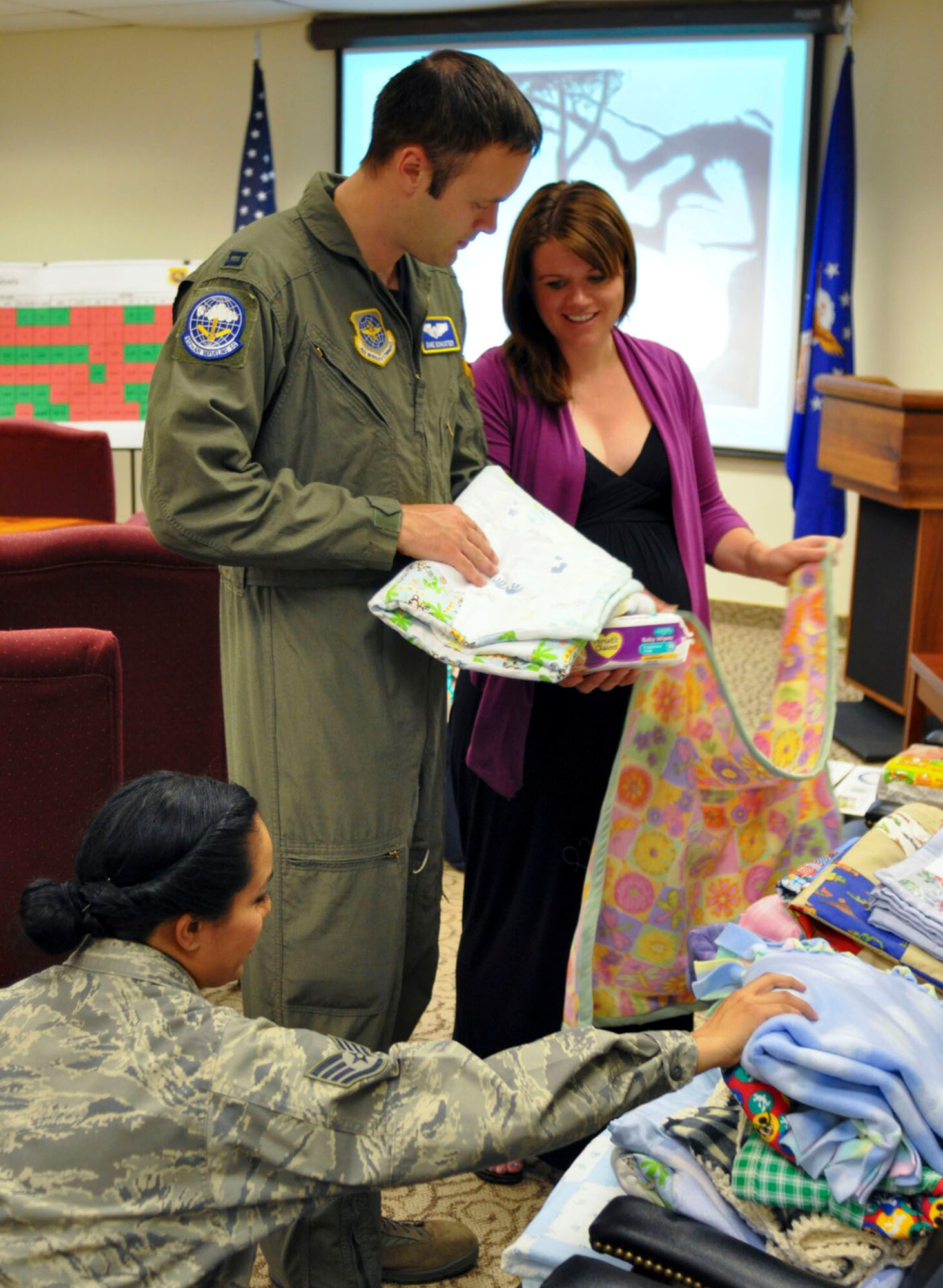 Capt. Dave Shuster, a KC-135 Stratotanker pilot with the 912th Air Refueling Squadron, and his wife, Annie, select a baby quilt after the Bundles for Babies course at March Air Reserve Base, Calif., June 7, 2011. Bundles for Babies is an Air Force Aid Society sponsored course that helps expectant parents be prepared for the costs of raising a child. The Schusters are expecting their first child. (U.S. Air Force photo/Megan Just)