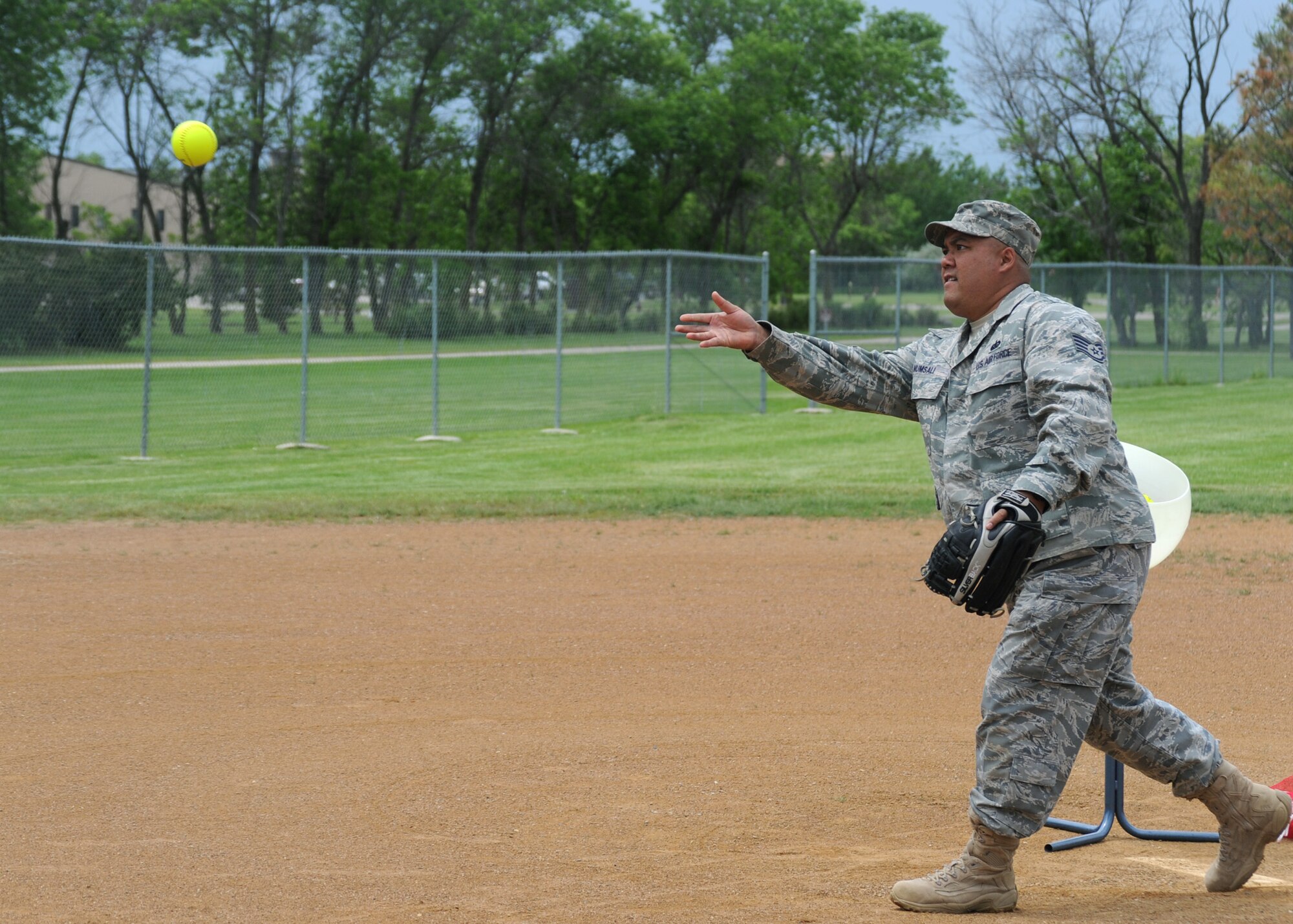 Staff Sgt. Prateep Numsali, 319th Force Support Squadron, pitches the softball to competitors June 24, 2011, during a Home Run Derby on Grand Forks Air Force Base, N.D. The Home Run Derby was held by the Base Fitness Center, inviting Airmen to compete for the most home runs. (U.S. Air Force photo by Senior Airman Amber Bennett)