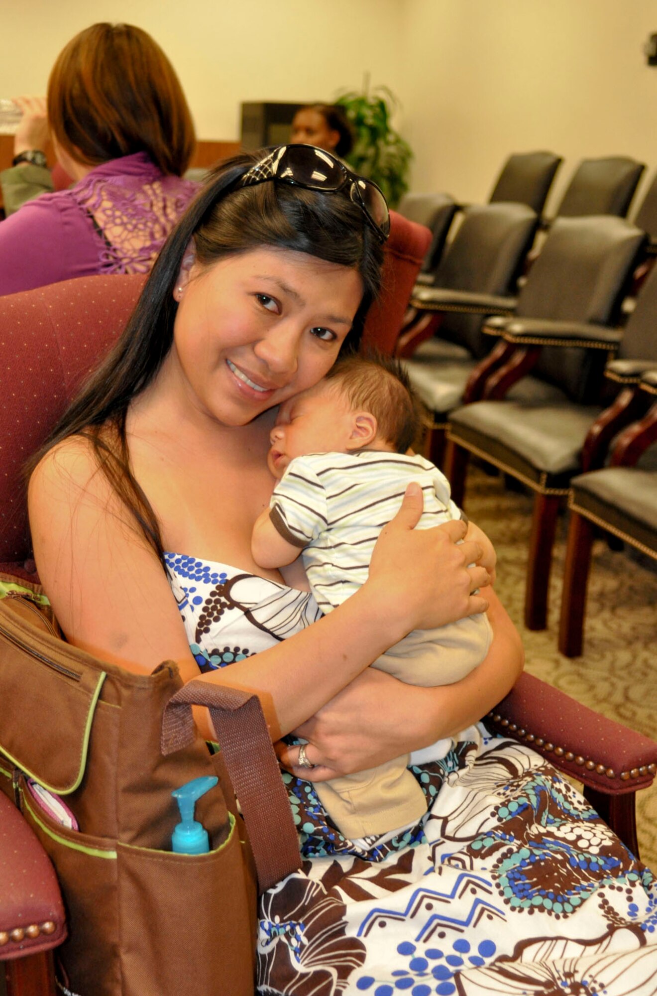 Master Sgt. Ellainne Bay, an air reserve technician with the 452nd Force Support Squadron, cuddles with her newborn son, Logan Bay, while waiting for the Bundles for Babies class to begin at March Air Reserve Base, Calif., June 7, 2011. Bundles for Babies is an Air Force Aid Society sponsored course that helps expectant parents be prepared for the costs of raising a child. (U.S. Air Force photo/Megan Just)