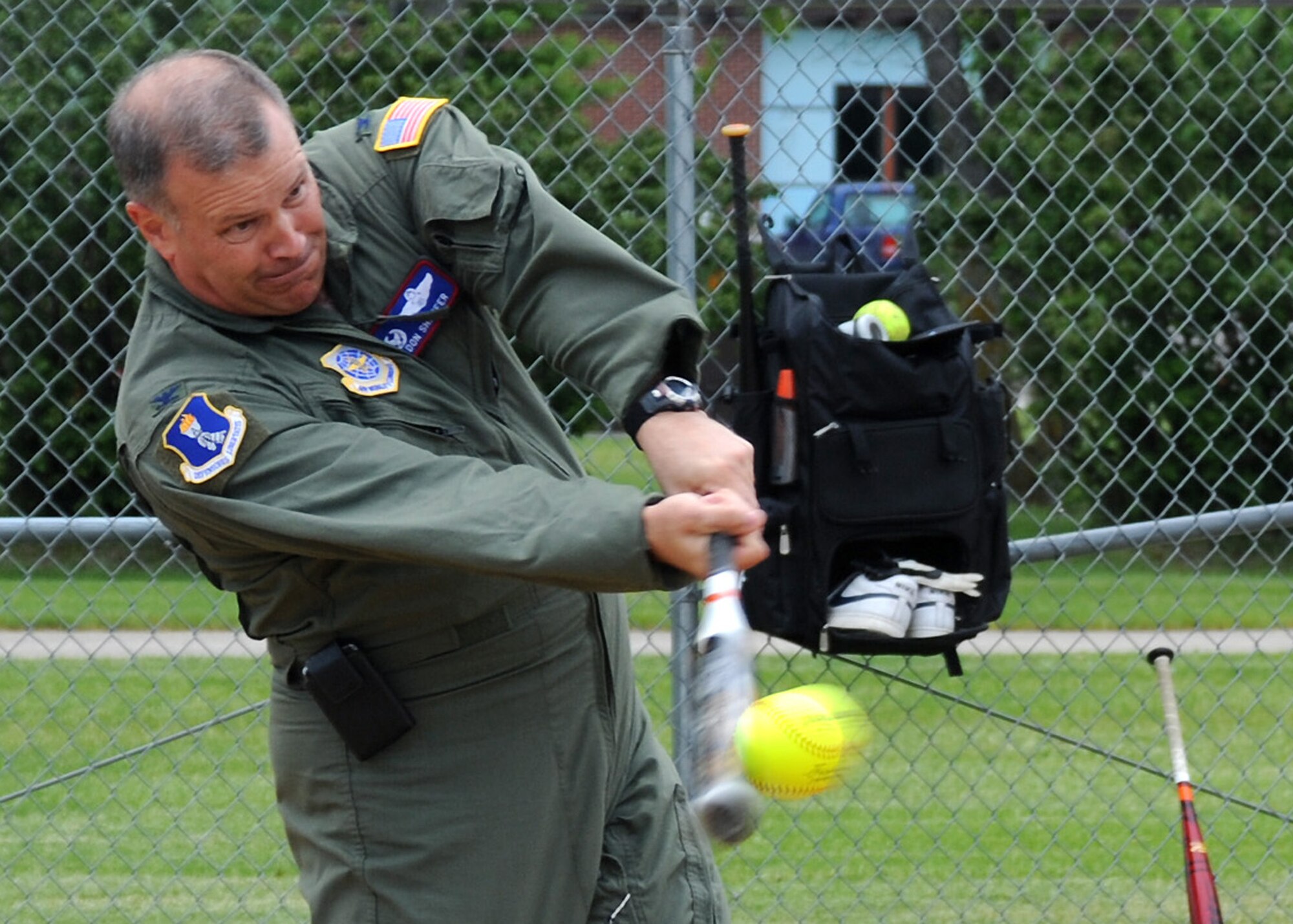 Col. Don Shaffer, 319th Air Base Wing commander, strikes the ball during a Home Run Derby June 24, 2011, on Grand Forks Air Force Base, N.D. The Home Run Derby was held by the Base Fitness Center, inviting Airmen to compete for the most home runs. (U.S. Air Force photo by Senior Airman Amber Bennett)