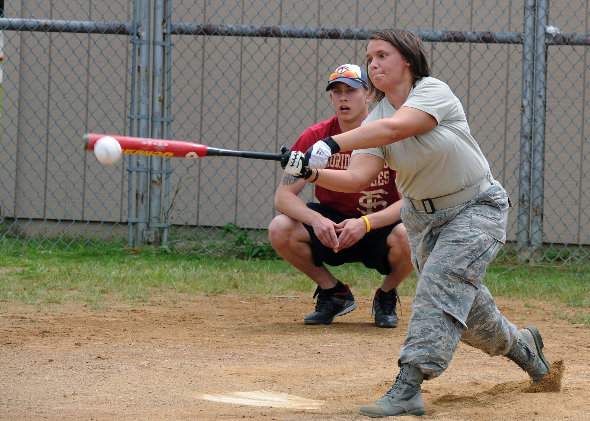 Senior Airman Amanda Bennett, 319th Force Support Squadron, strikes the ball during a Home Run Derby June 24, 2011, on Grand Forks Air Force Base, N.D. The Home Run Derby was held by the Base Fitness Center, inviting Airmen to compete for the most home runs. (U.S. Air Force photo by Senior Airman Amber Bennett)