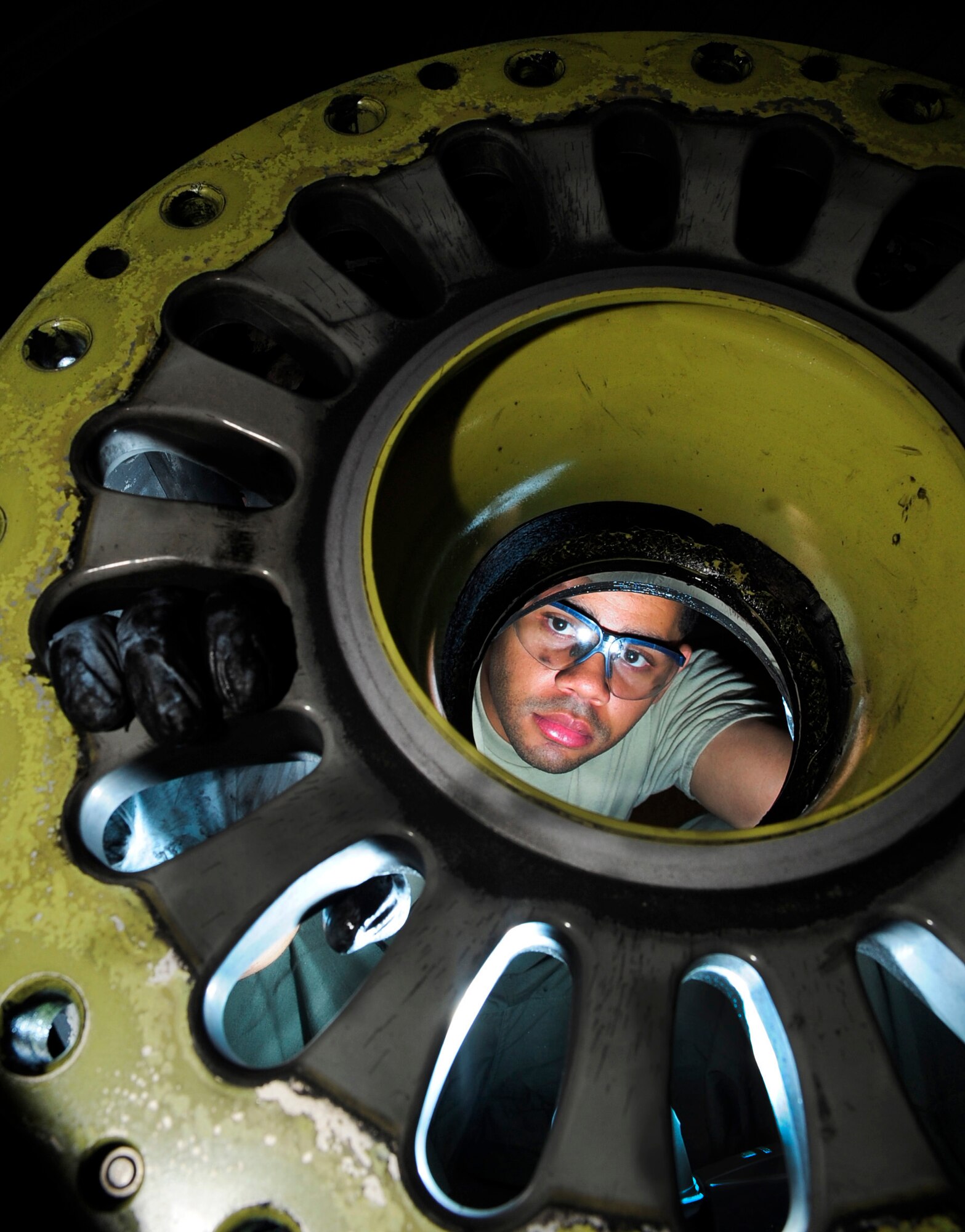 RAF MILDENHALL, England -- Staff Sgt. Daniel Fowler, 100th Maintenance Squadron aero repair craftsman, ensures all bolts are removed from the wheel assembly prior to removing the tire from the wheel here June 20, 2011. After the bolts are removed, they are cleaned and then sent to the non-destructive inspection lab to be cleared for future use. (U.S. Air Force photo/Senior Airman Ethan Morgan)