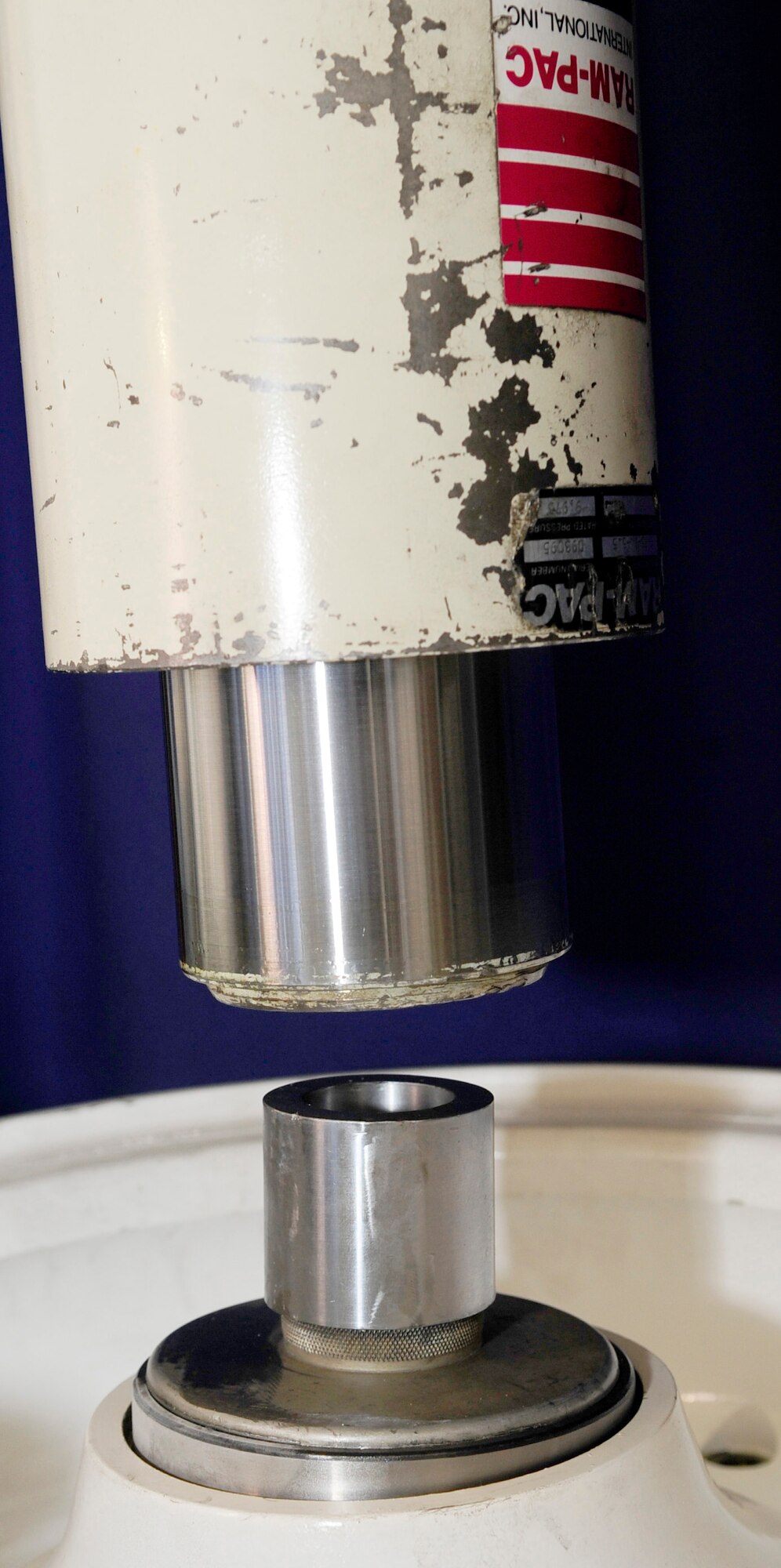 RAF MILDENHALL, England -- A hydraulic press is lowered onto an alignment tool to set a bearing cup for a KC-135 Stratotanker nose landing wheel into place here June 15, 2011. The alignment tool is used to ensure that the bearing cup is evenly pressed into place to prevent malfunction. (U.S. Air Force photo/Senior Airman Ethan Morgan)