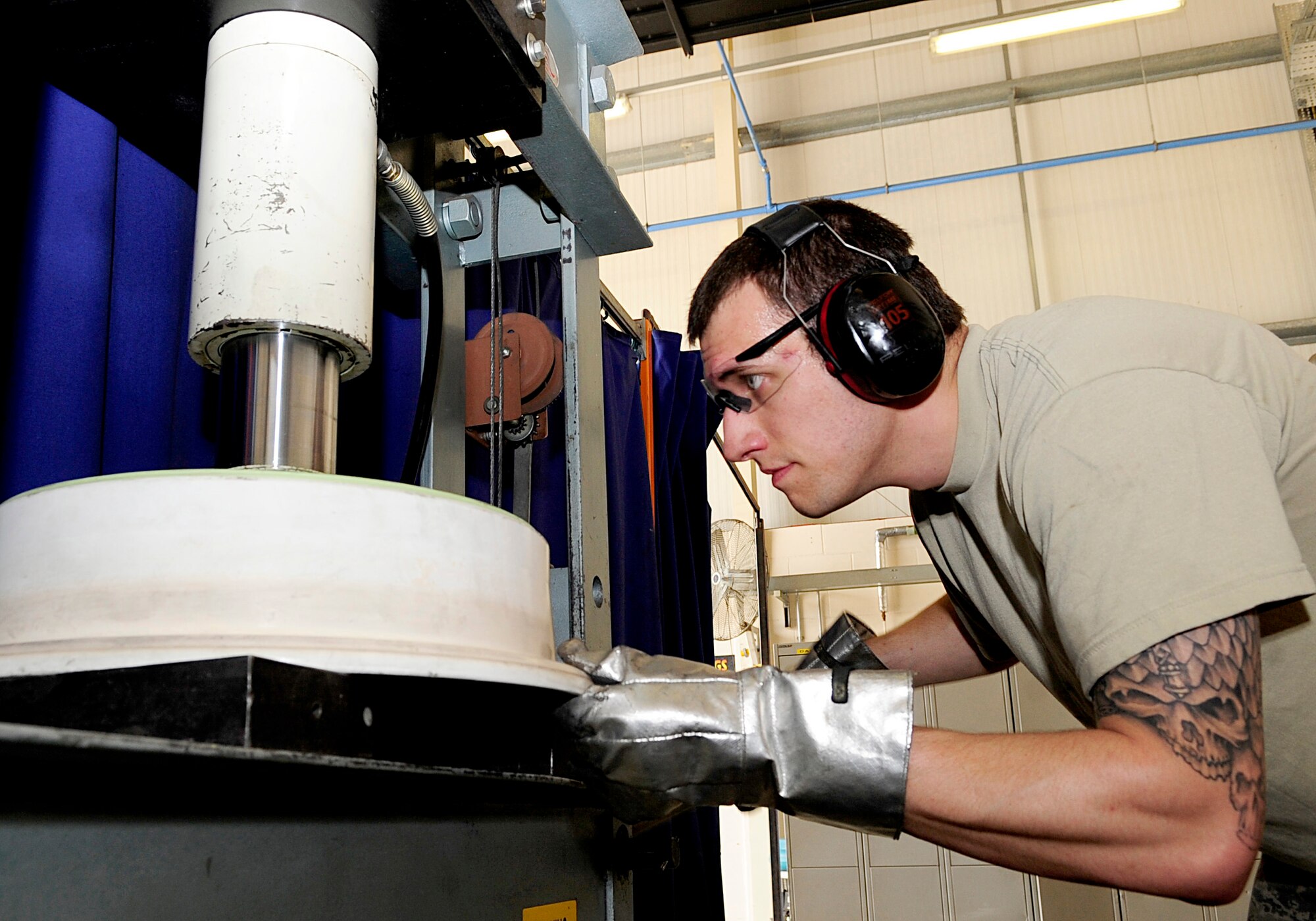 RAF MILDENHALL, England -- Staff Sgt. Dustin Neal, 100th Maintenance Squadron aero repair craftsman, uses a hydraulic press to remove a KC-135 Stratotanker nose landing wheel bearing cup here June 15, 2011. The bearing cup is removed and replaced, to ensure proper rotation on the axel while on the KC-135. (U.S. Air Force photo/Senior Airman Ethan Morgan)