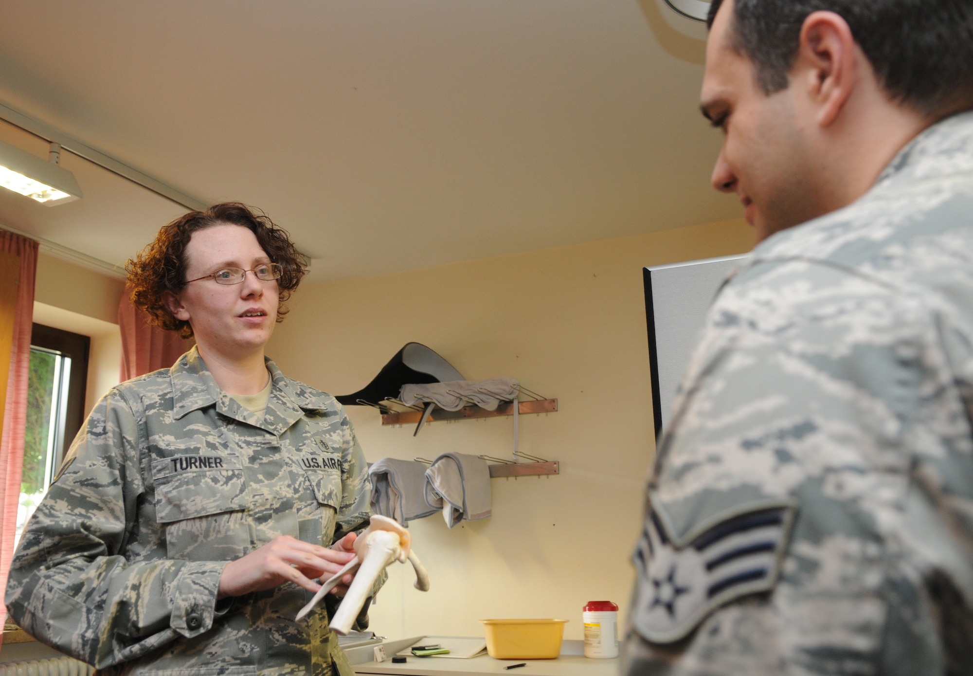 SPANGDAHLEM AIR BASE, Germany – Tech. Sgt. Jaime Turner, 52nd Medical Operation Squadron physical therapy NCO in charge, explains to Senior Airman Jarrod Garceau, 52nd MDOS physical therapy technician, about the shoulder bone structure and common shoulder injuries that occur among patients here June 13. The 52nd MDOS Physical Therapy Section is available to lend a hand when it comes to helping patients alleviate pain and regain their physical abilities. (U.S. Air Force photo/Senior Airman Nick Wilson)