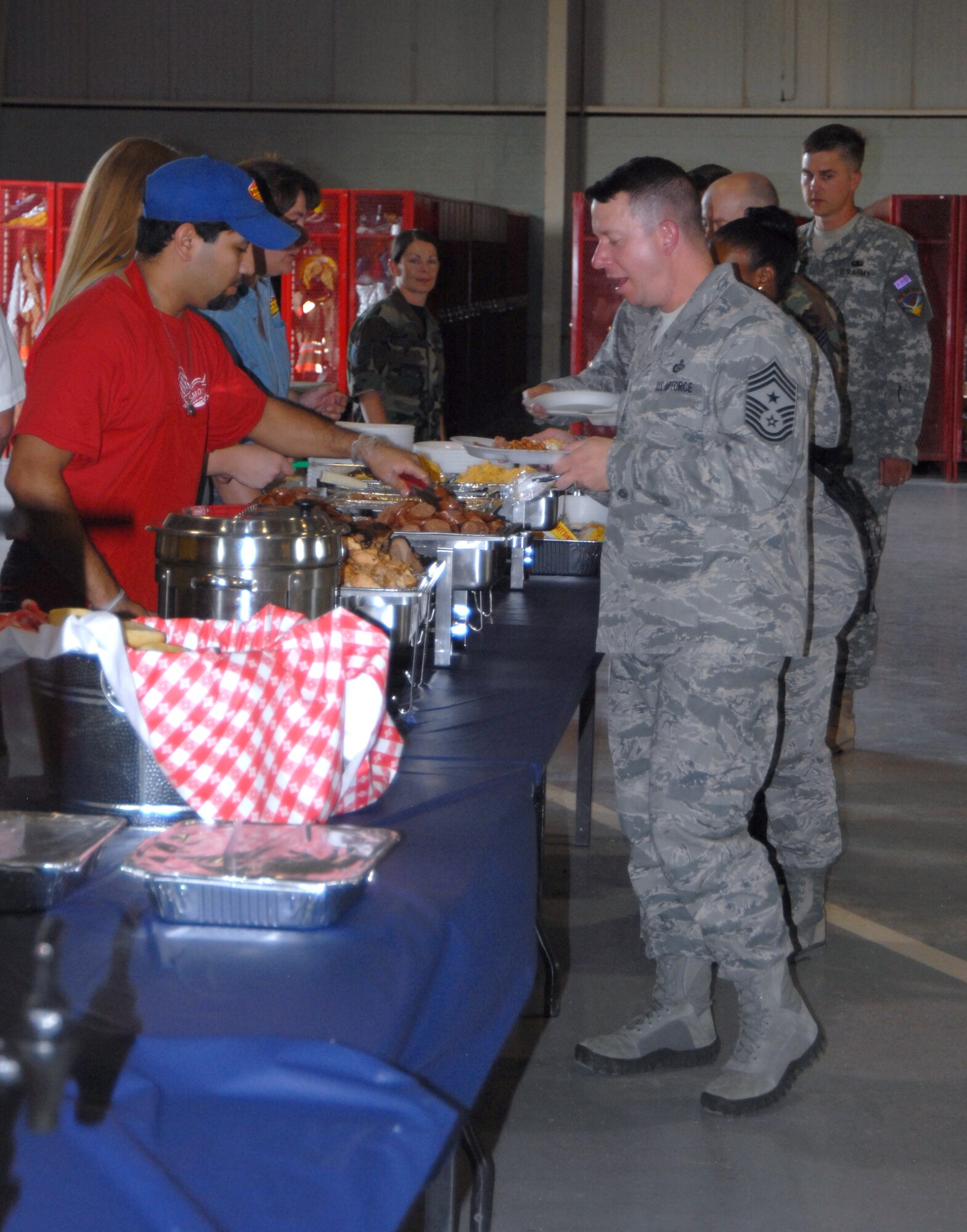 GOODFELLOW AIR FORCE BASE, Texas— Chief Master Sgt. Brendan Criswell, 17th Training Wing Command Chief, opens up the dinner line at the Joint Enlisted Combat Dining In June 18. The formal dinner was catered by a local restaurant, which served a wide variety of food to more than 300 servicemembers. (U.S. Air Force photo/Airman 1st Class Jessica Keith)