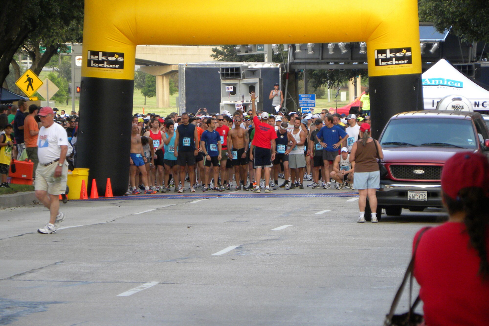A race official prepares to start the “Wounded Warrior Half Marathon 10K and Military Mile Fun Run” in Los Colinas, Texas, June 12, 2011. At least three Airmen from the 307th Bomb Wing at Barksdale Air Force Base, La., competed in the race. According to the Wounded Warrior website, more than 1,500 runners took part in the event to honor our men and women of the military and help raise money for the Semper Fi Fund, which provides assistance to Marines and Sailors injured in post 9-11 combat, and ReserveAid, which gives financial support to Reserve Service Members from all branches of the military. (Courtesy photo by Scott Moeller)