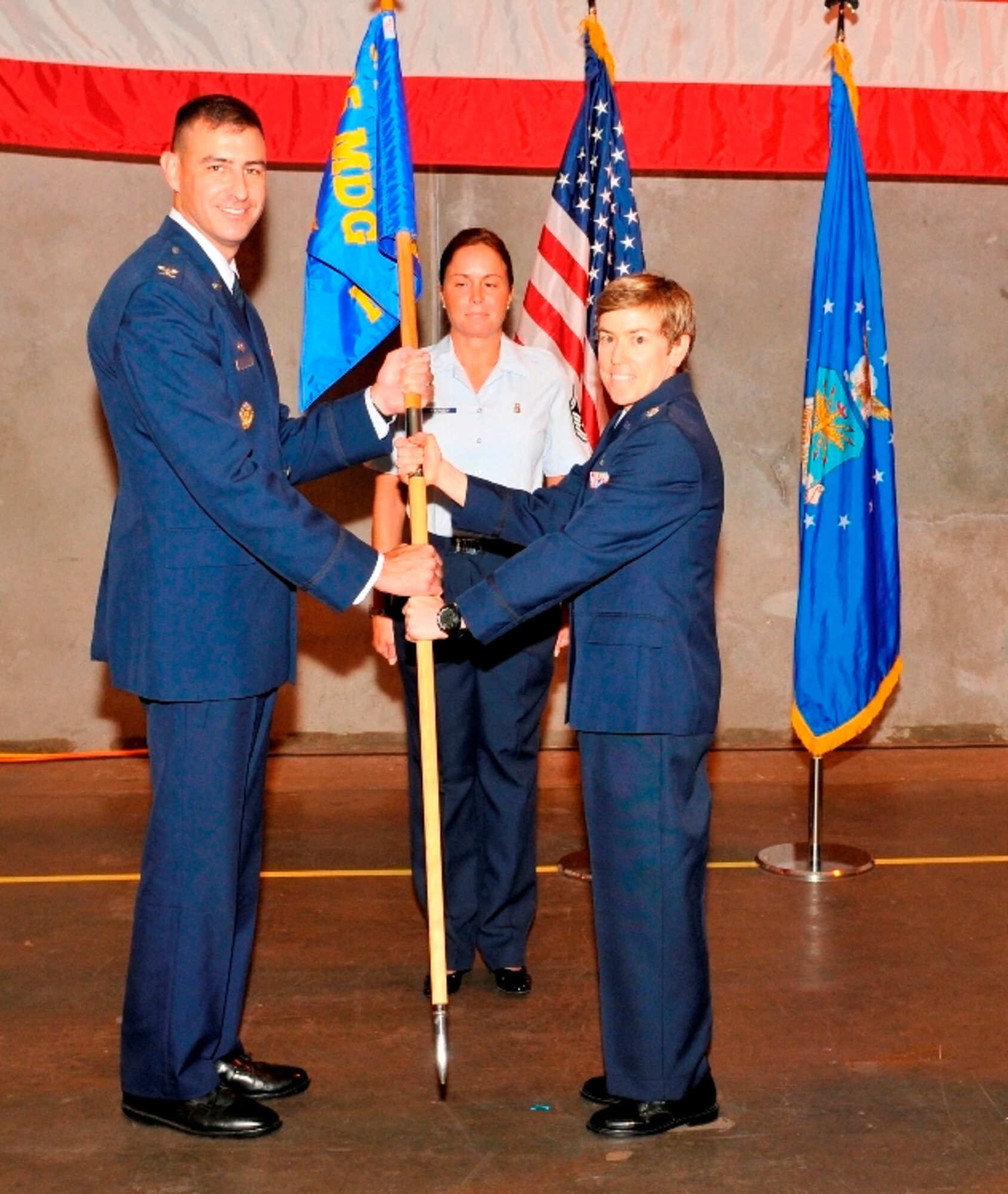 Colonel Paul Skala, 325th Medical Group commander, passes command of the 325th Medical Support Squadron to Lt. Col. Shannon Phares during a change of command ceremony June 17. Colonel Phares replaces Lt. Col. Shari Silverman who departs Tyndall to Andrews Air Force Base, Washington D.C. Colonel Phares arrives from Joint Base Anacostia-Bolling, Washington D.C., where she served as the director of aerospace physiology. (U.S. Air Force photo by Lisa Norman) 